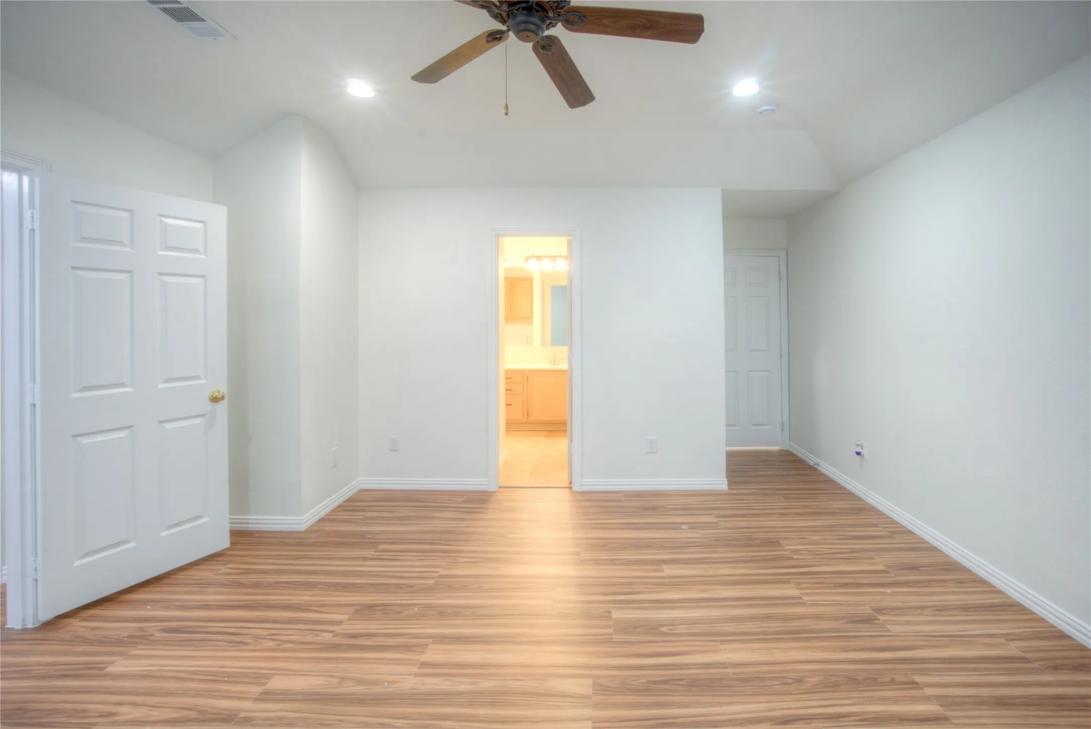 Wood-finish flooring, recessed lighting, and a ceiling fan