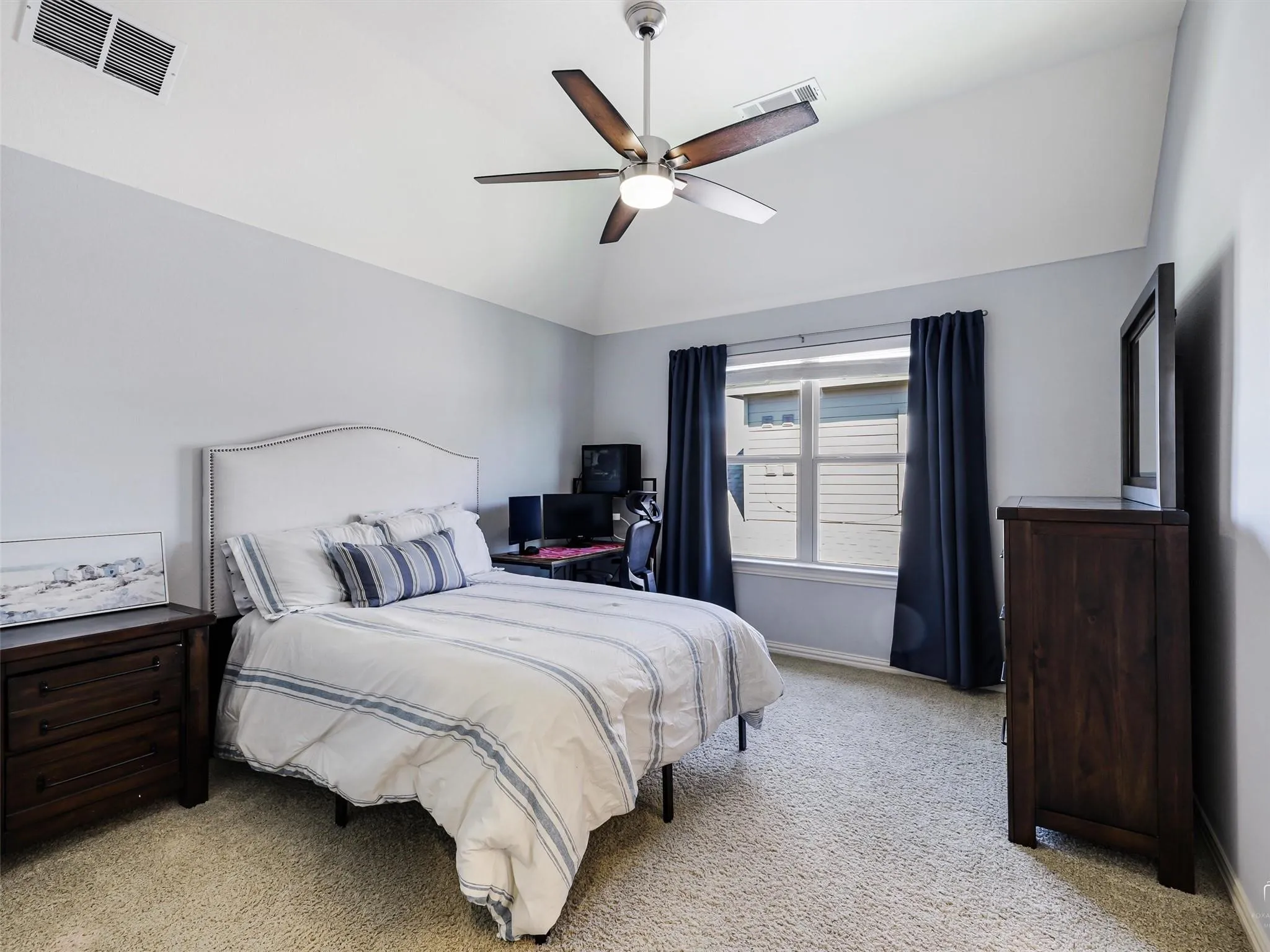 Vaulted ceiling with a ceiling fan, carpet flooring, a window with blinds, and light-colored walls