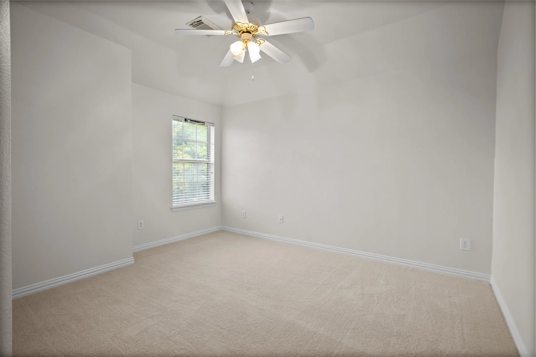 Neutral wall paint, carpeted flooring, window with blinds, and ceiling fan
