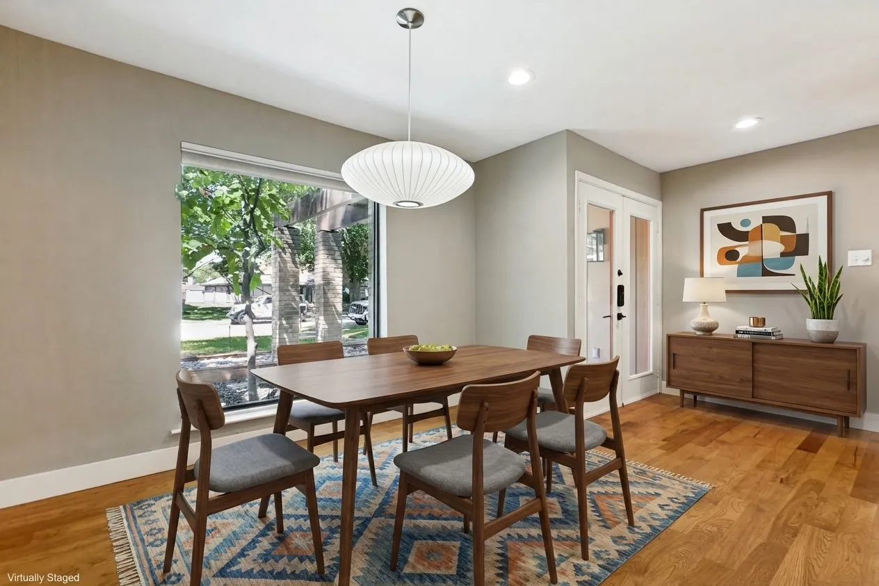Hardwood flooring, recessed lighting, and a large window providing ample natural light