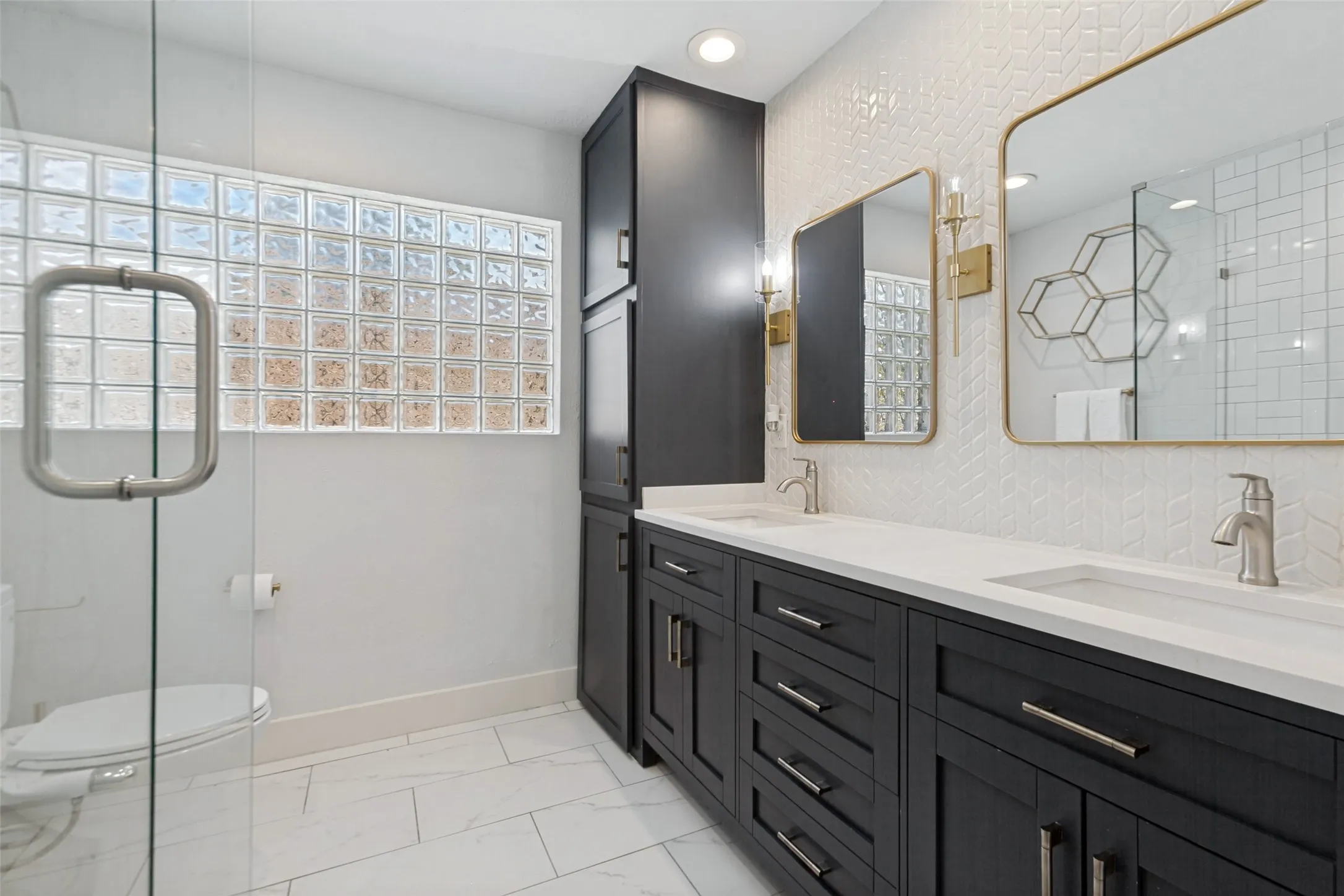 Dual vanity with integrated sinks, dark wood-finish cabinetry, and white countertops