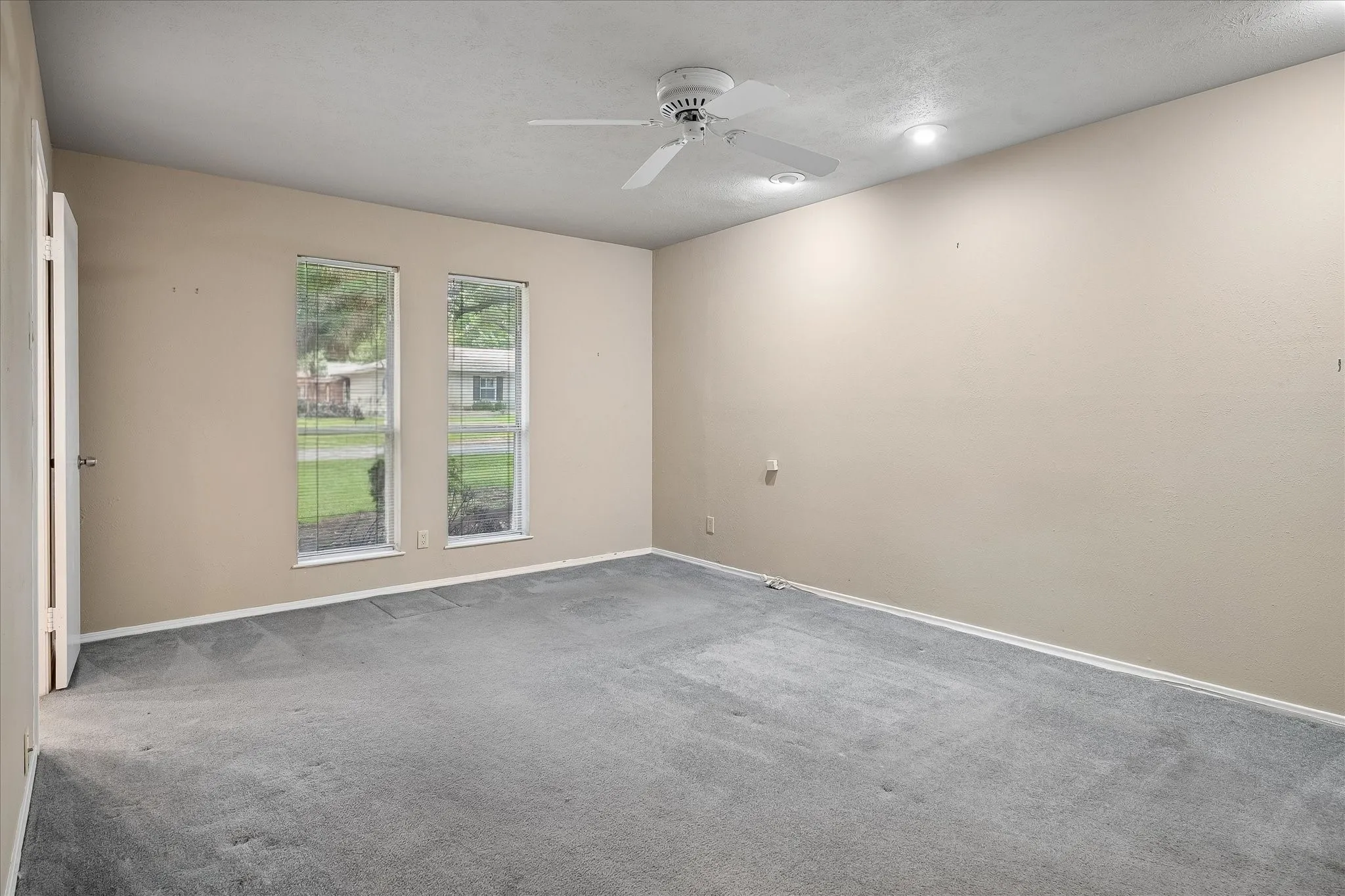 Bedroom with tree-lined window views and access to a shared Jack-and-Jill bathroom.