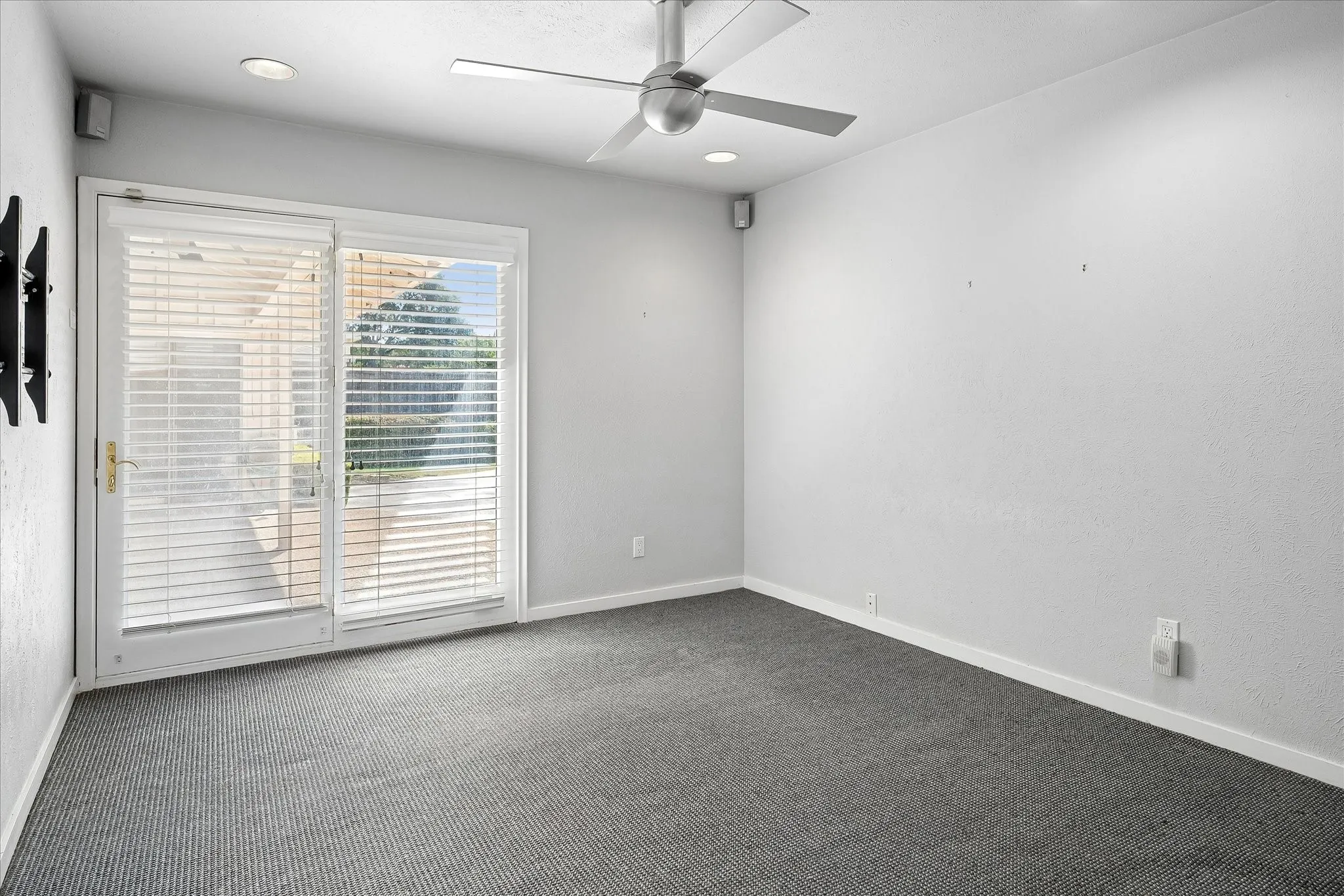 Easily converted to a fourth bedroom with ceiling fan and French doors to the patio.