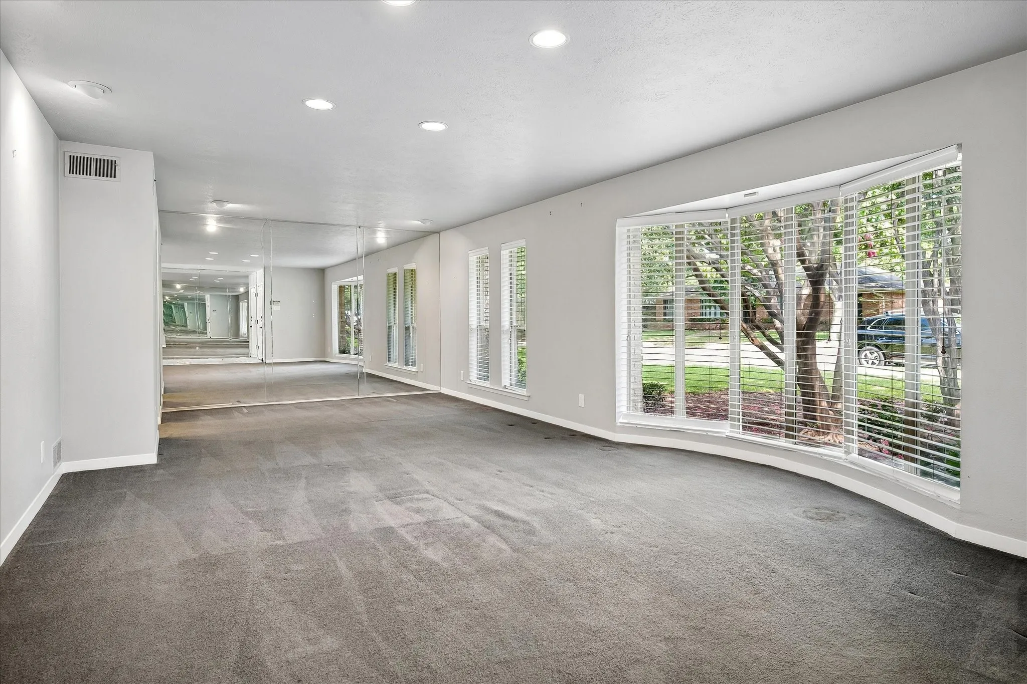 Spacious formal living area with curved bay window that floods the room with natural light.