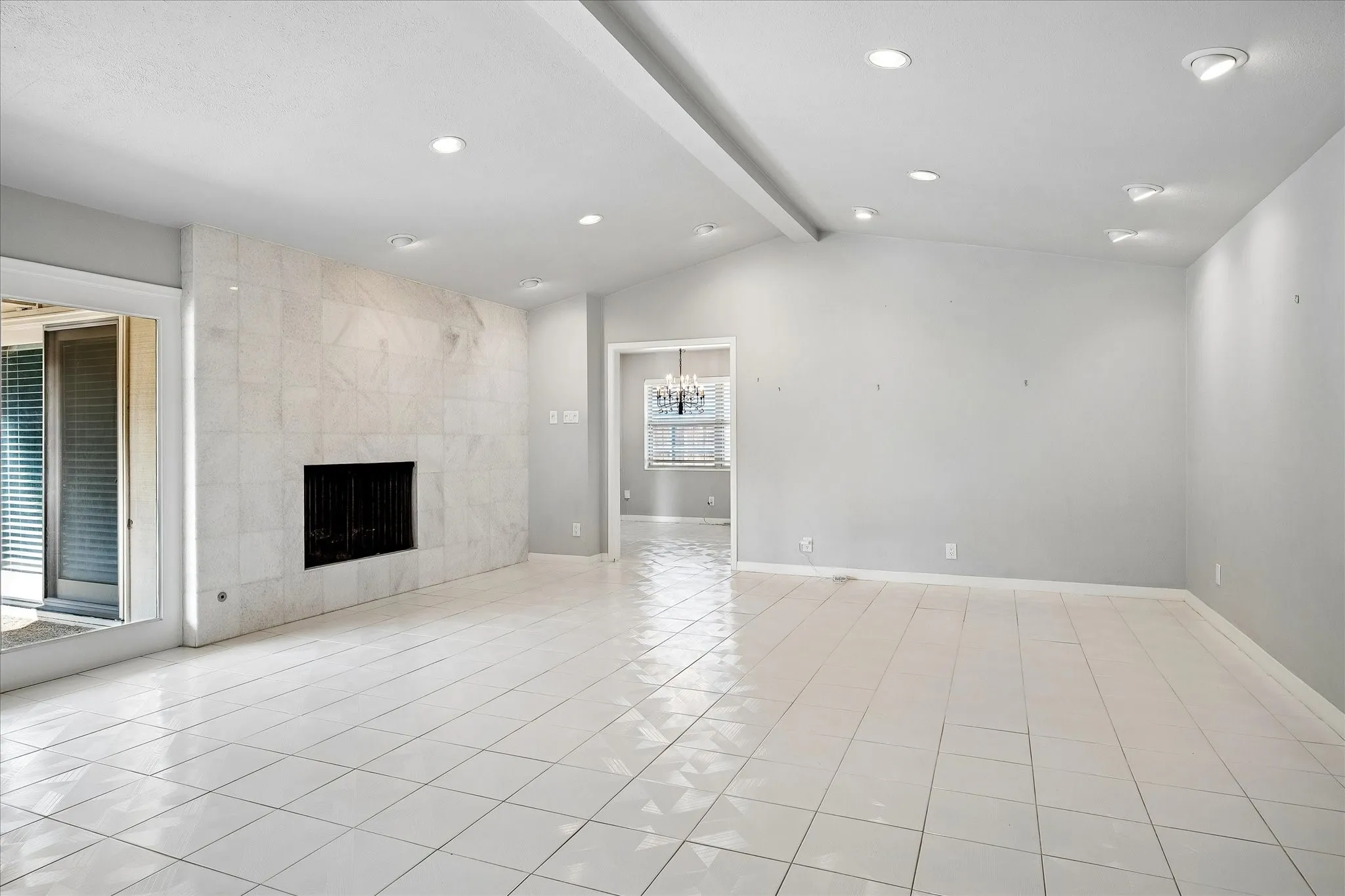 Family room with marble wood burning fireplace and French doors to the pool.