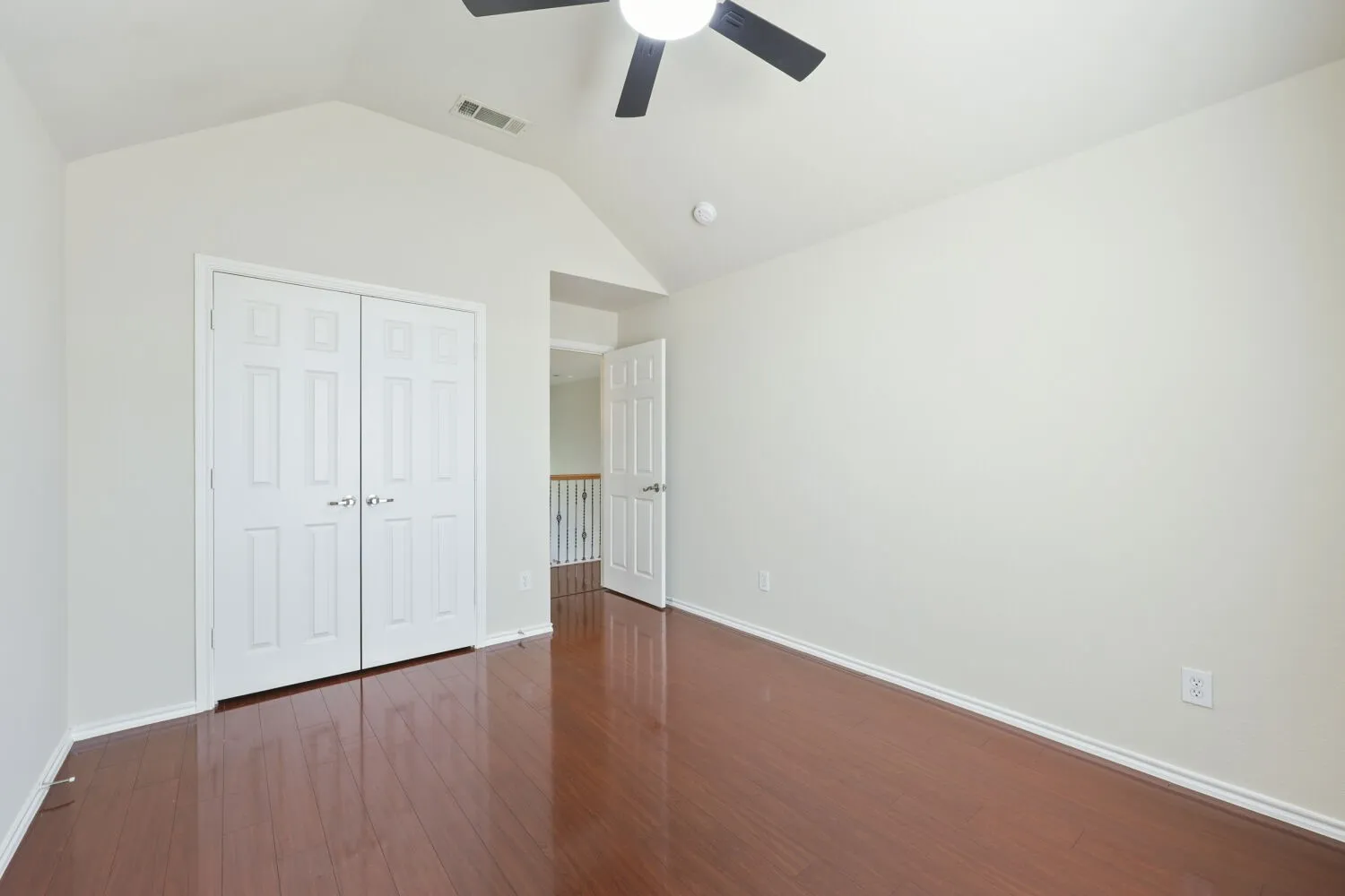 Wood-finish flooring, vaulted ceiling, ceiling fan, bi-fold closet doors, white trim