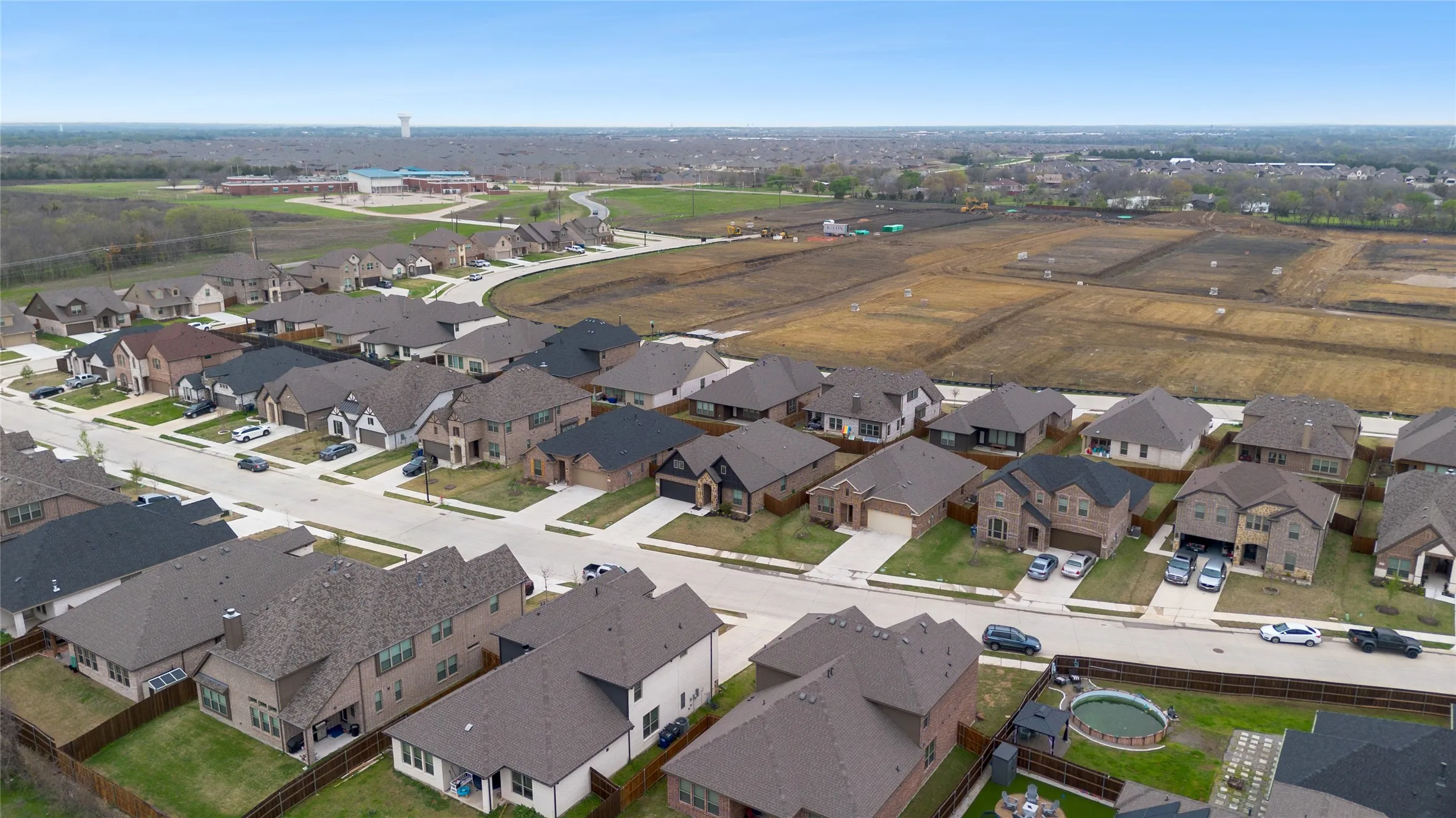 Residential development featuring single-family homes with pitched roofs and attached garages