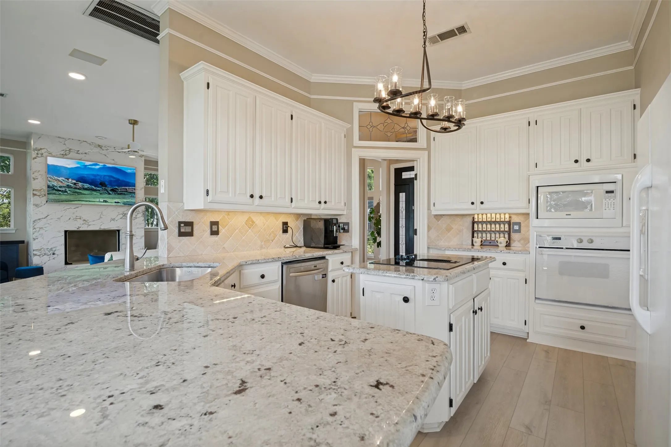 Beautiful kitchen with an island that opens up into the breakfast area and living room.