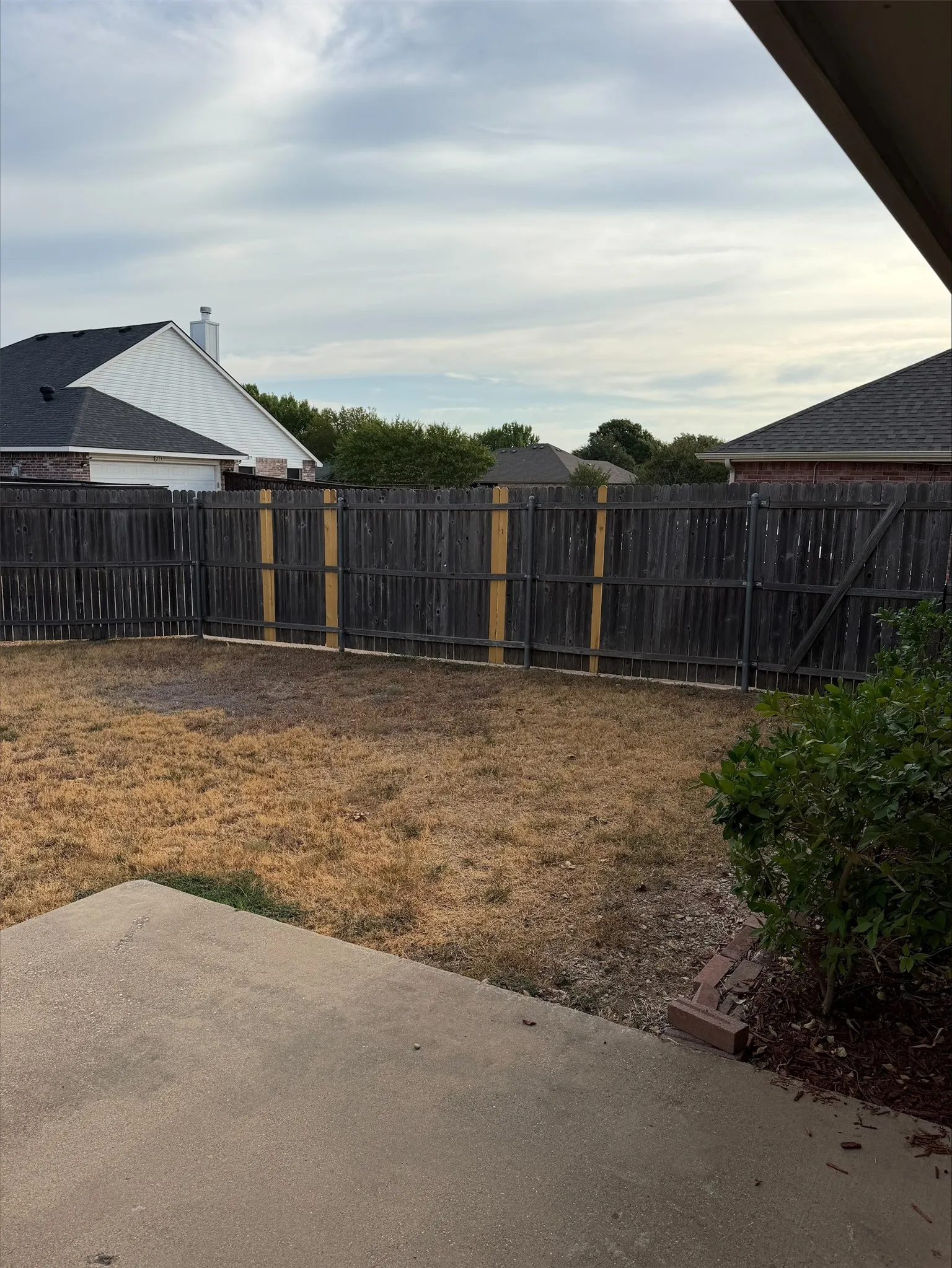 Concrete patio with wood privacy fencing