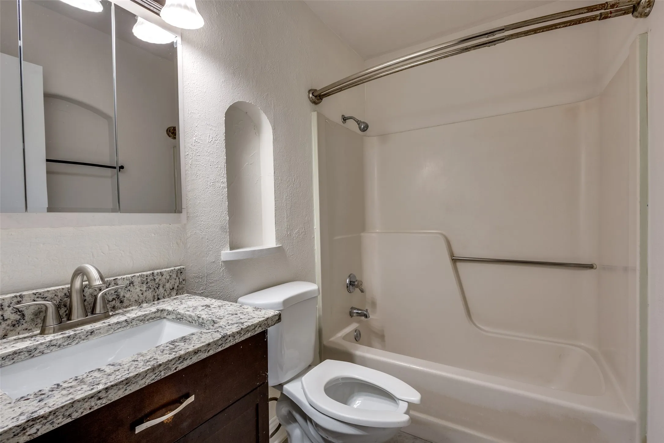 Full bathroom featuring toilet, vanity, and shower / bath combination