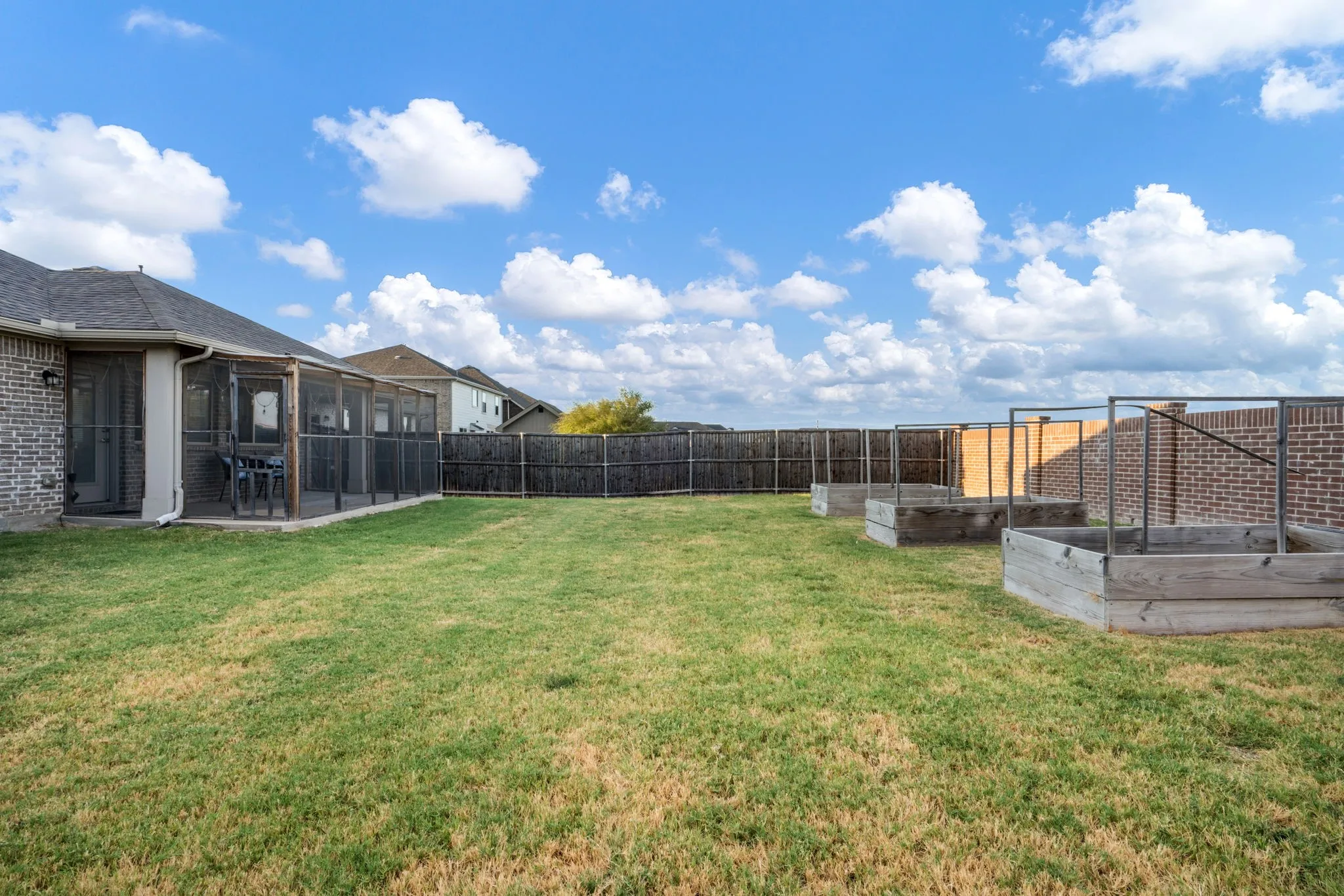 Large Grassy Yard with 3 Above Ground Planters for Gardening