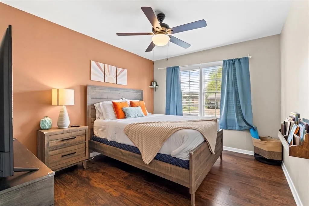 Wood-finish flooring, ceiling fan, and built-in shelving