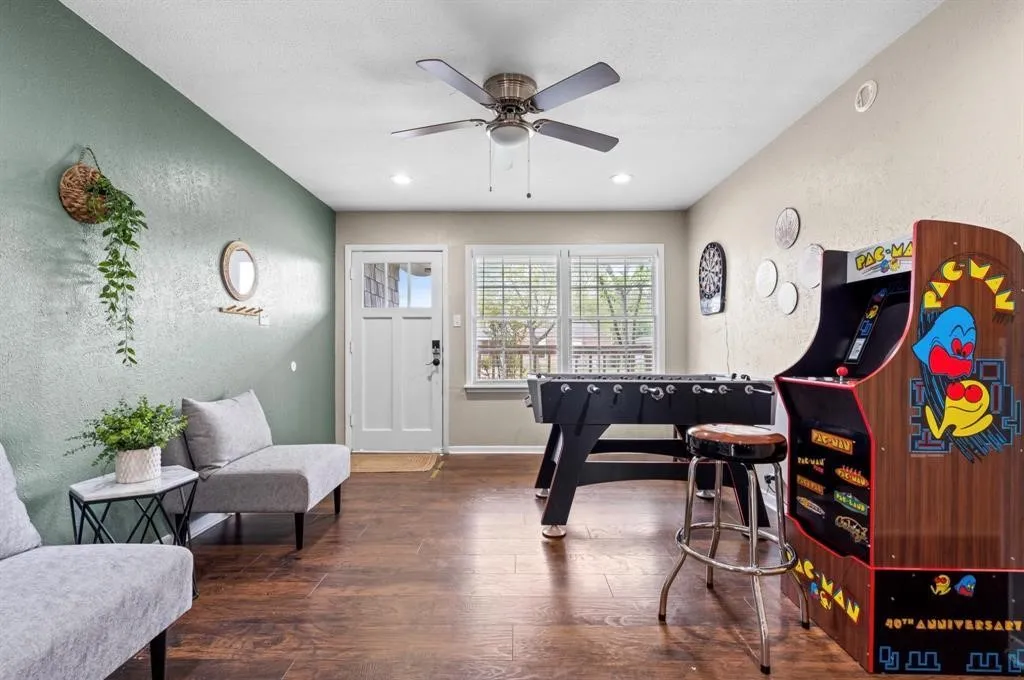 Wood-finish flooring throughout, recessed lighting, and a ceiling fan with integrated lighting