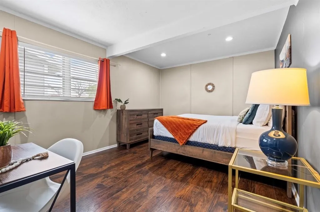 Wood-finish flooring, recessed lighting, and a window with blinds
