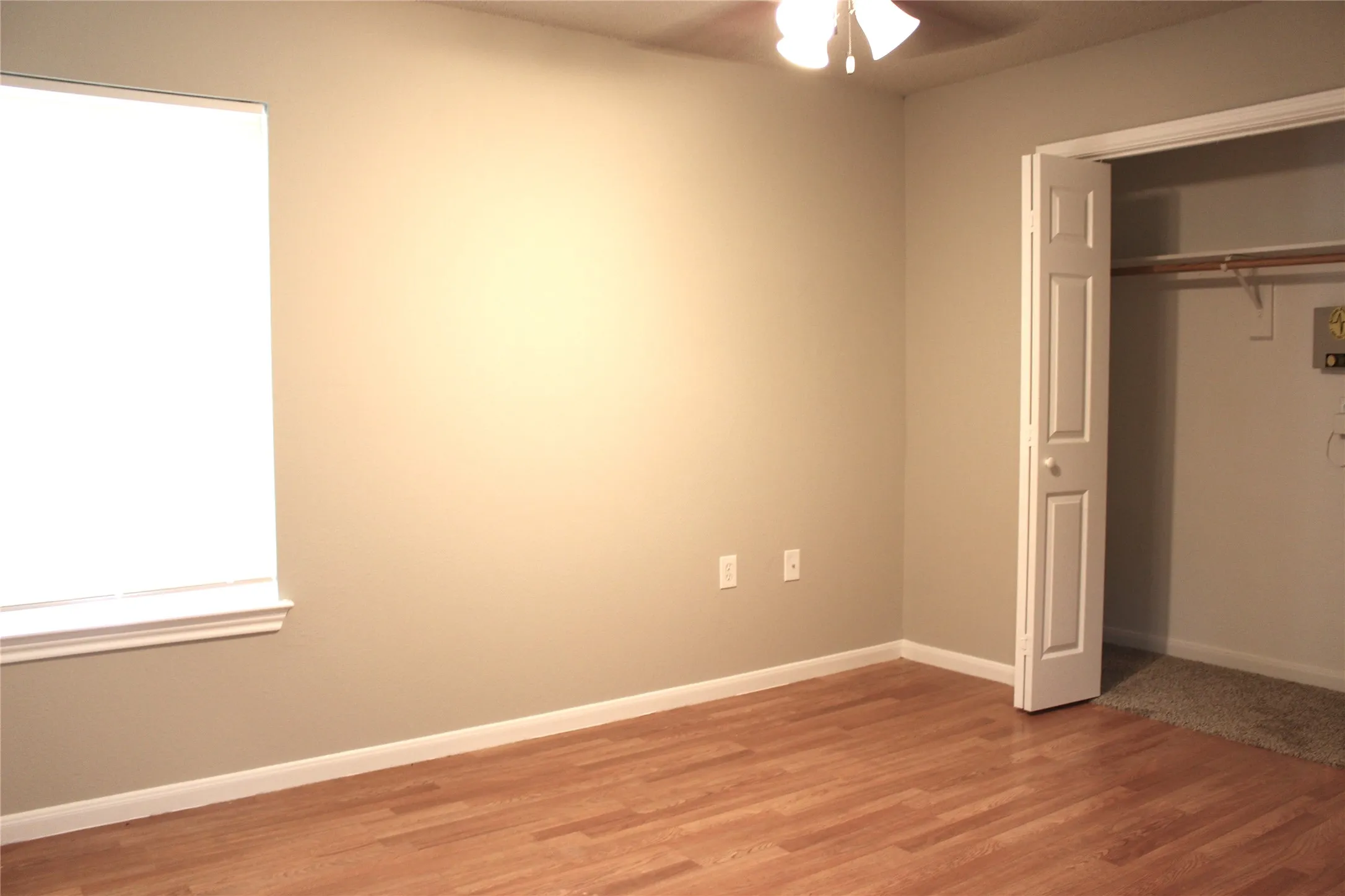 Wood-finish flooring with neutral wall paint and white trim