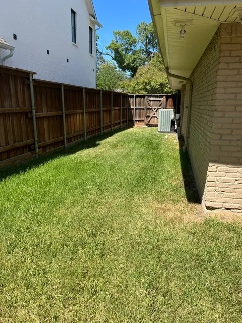 Expansive side yard with a full-height wood privacy fence