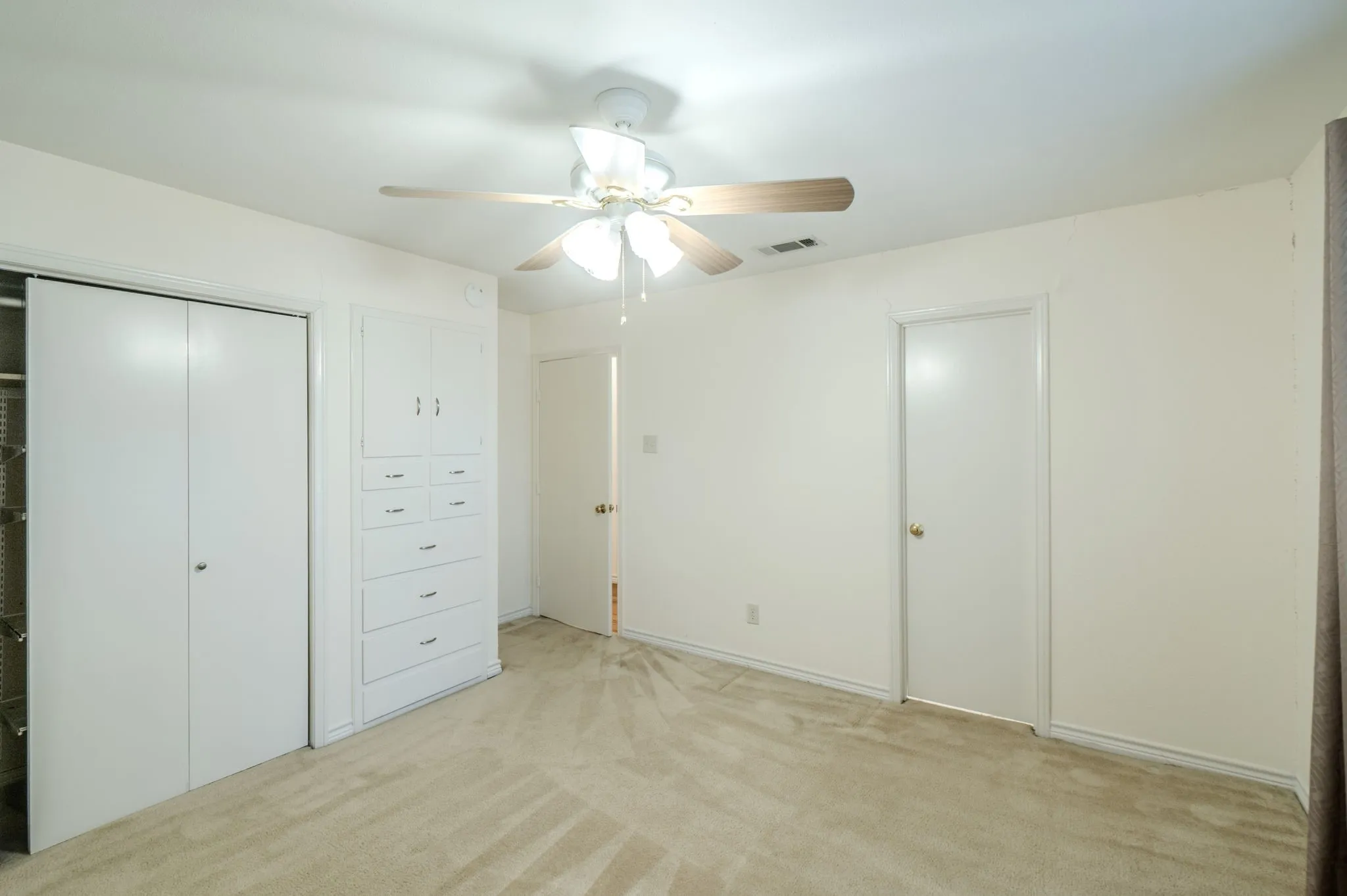 Bed 3 Carpeted flooring, built-in storage cabinetry, ceiling fan with integrated lighting, and a closet with sliding doors