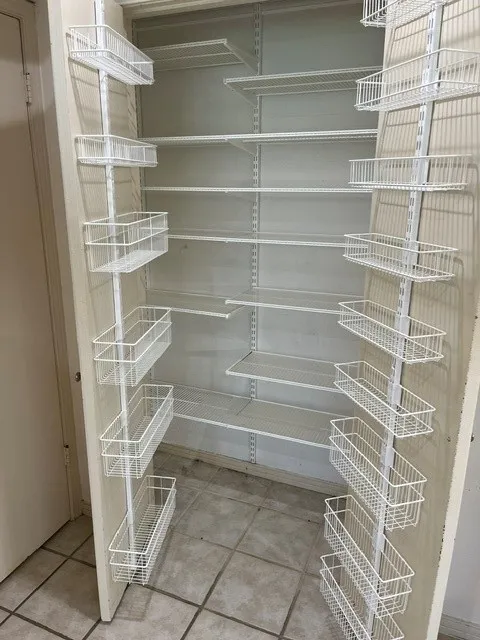 Adjustable wire shelving system with integrated wire baskets and tile flooring