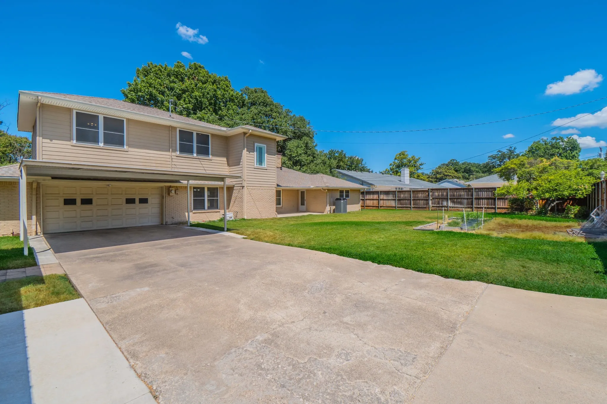 Two-story exterior with light-colored siding and brick accents Total covered parking 6