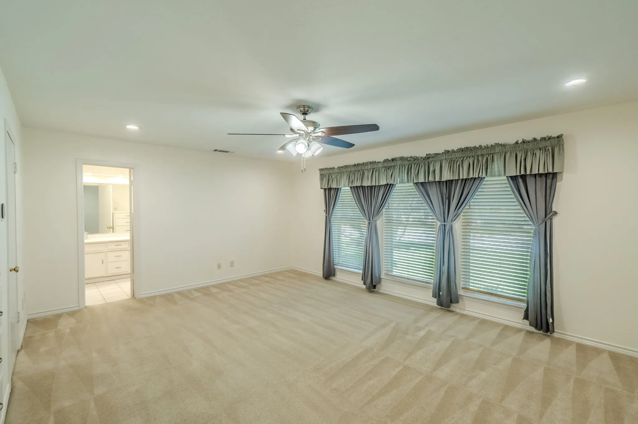 Recessed lighting, ceiling fan, and carpeted flooring