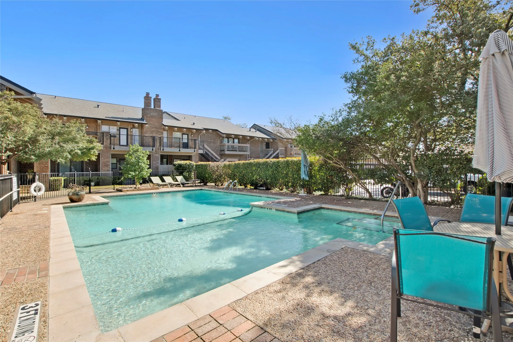Community pool with a residential view