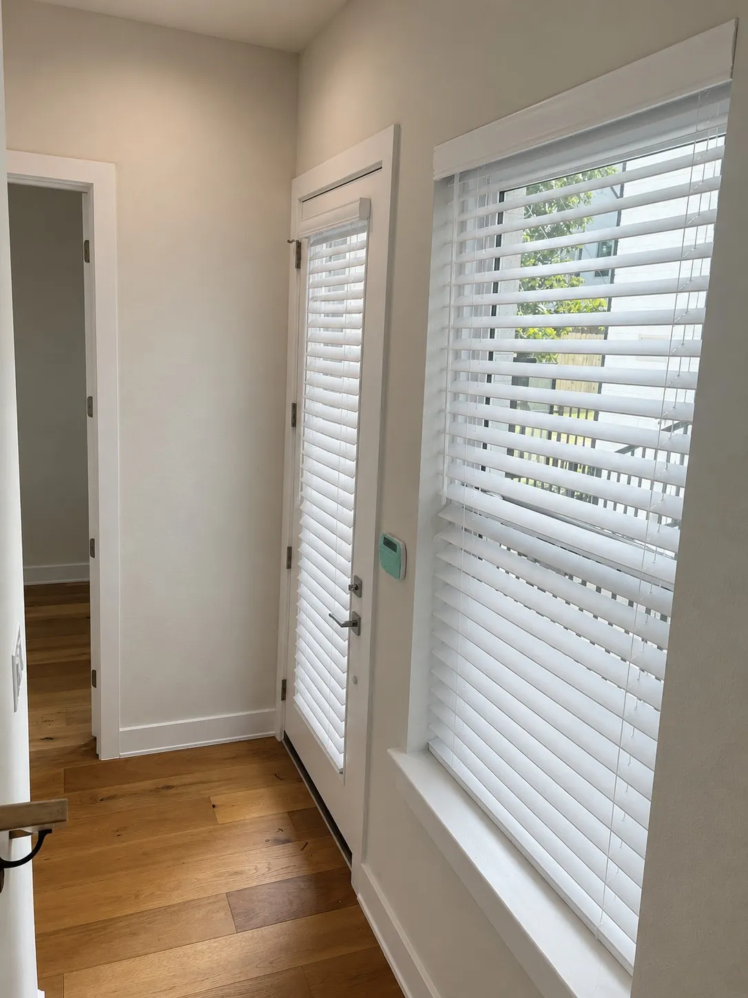 Alarm system at entry and flex space. Blinds generated by AI showing what is being installed.