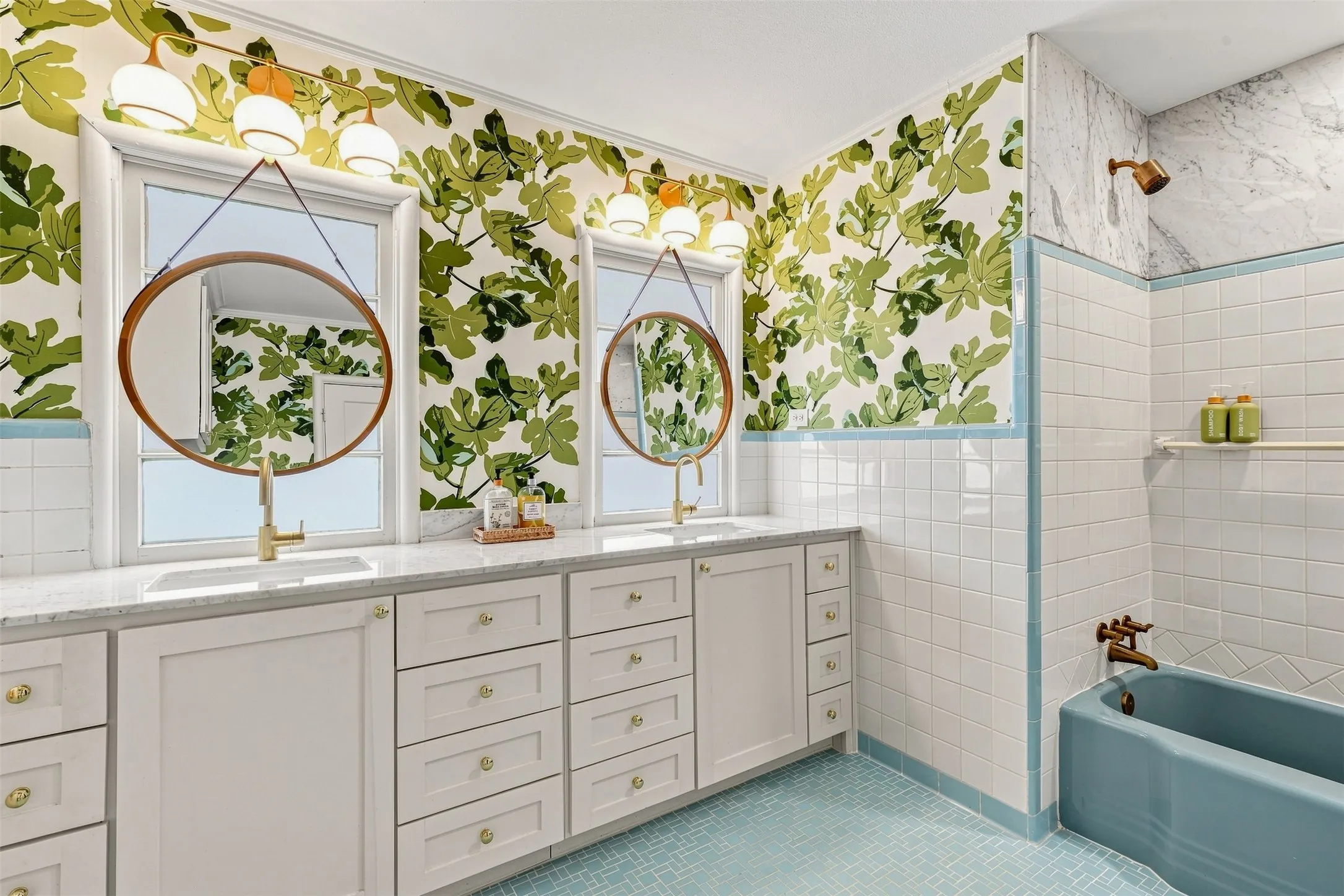The bathroom beautifully celebrates the home's original character, featuring charming vintage tile complemented by fresh wallpaper and fixtures.