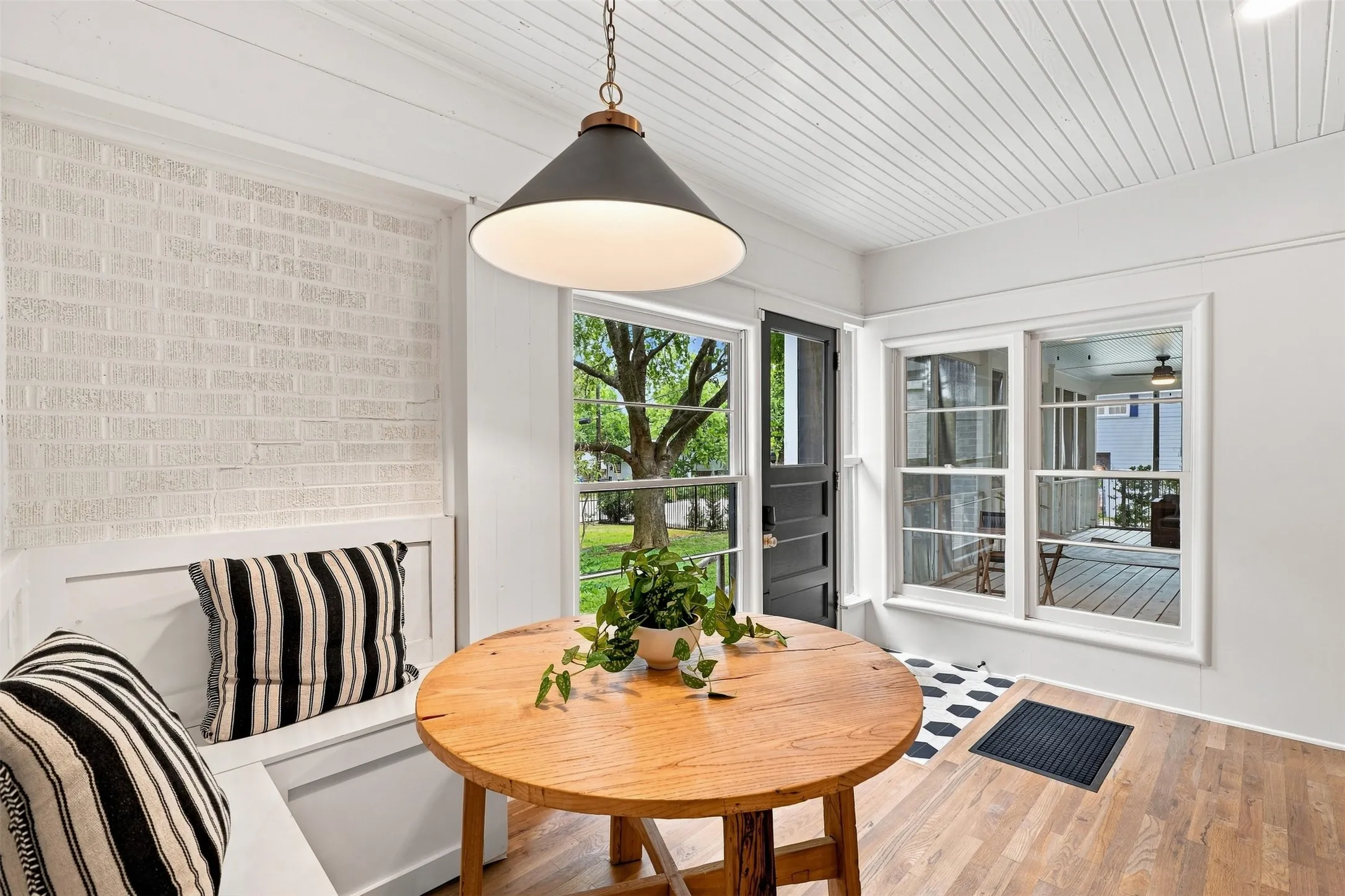 A charming breakfast nook with built- in banquette seating creates an intimate setting for morning coffee, or quiet conversations. Thoughtfully tucked off the kitchen adding space and character.