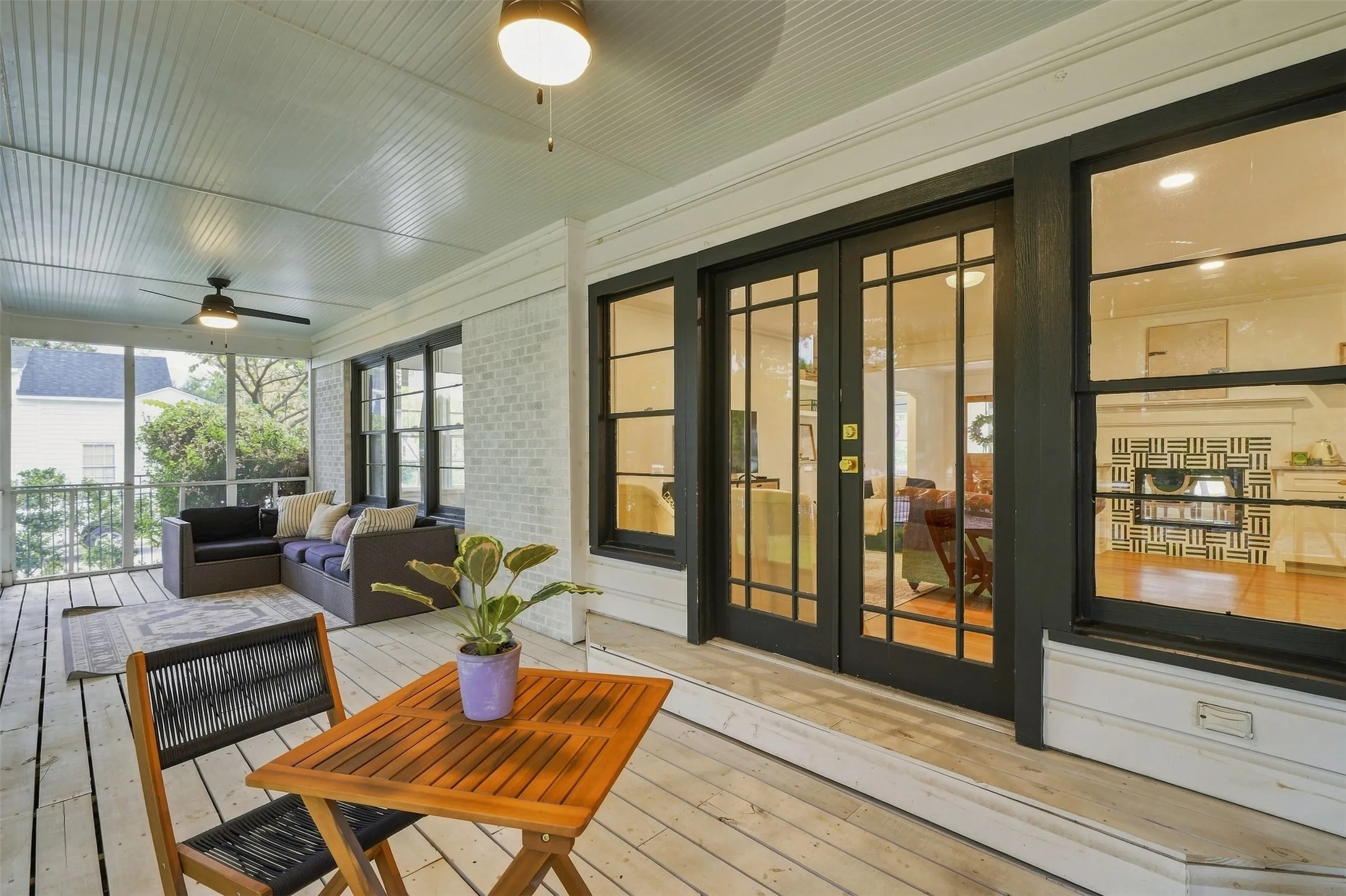 Relax on the enclosed sunroom steps away from the living area and stunning back yard
