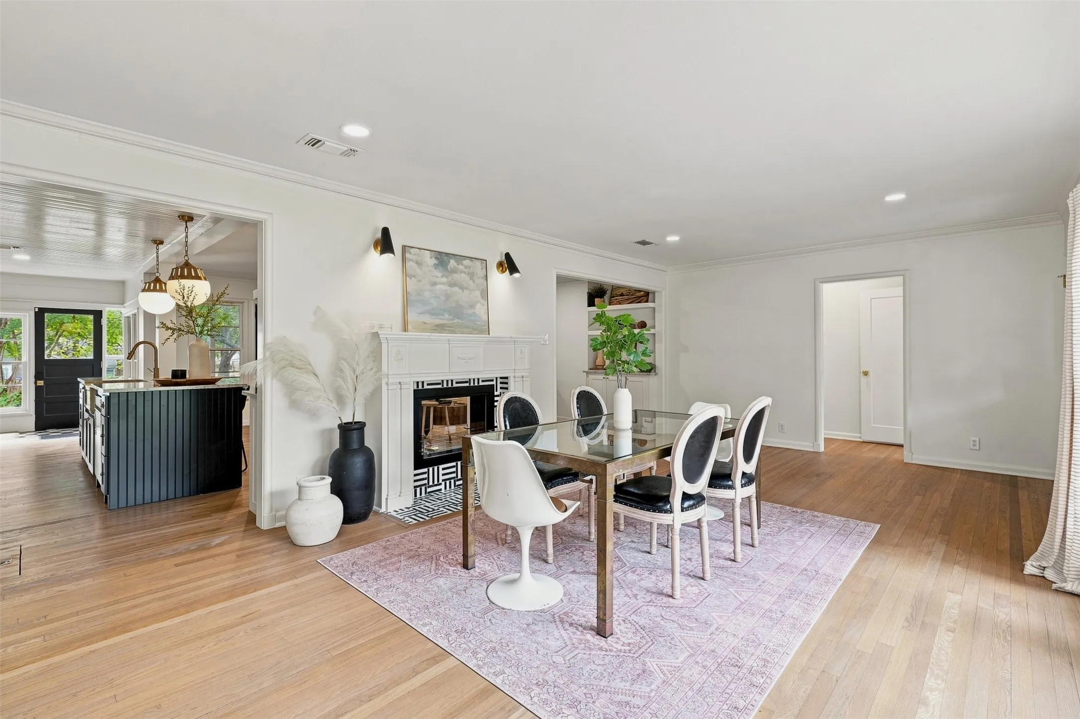 A charming sitting and dining area welcomes you at the front door of the home.