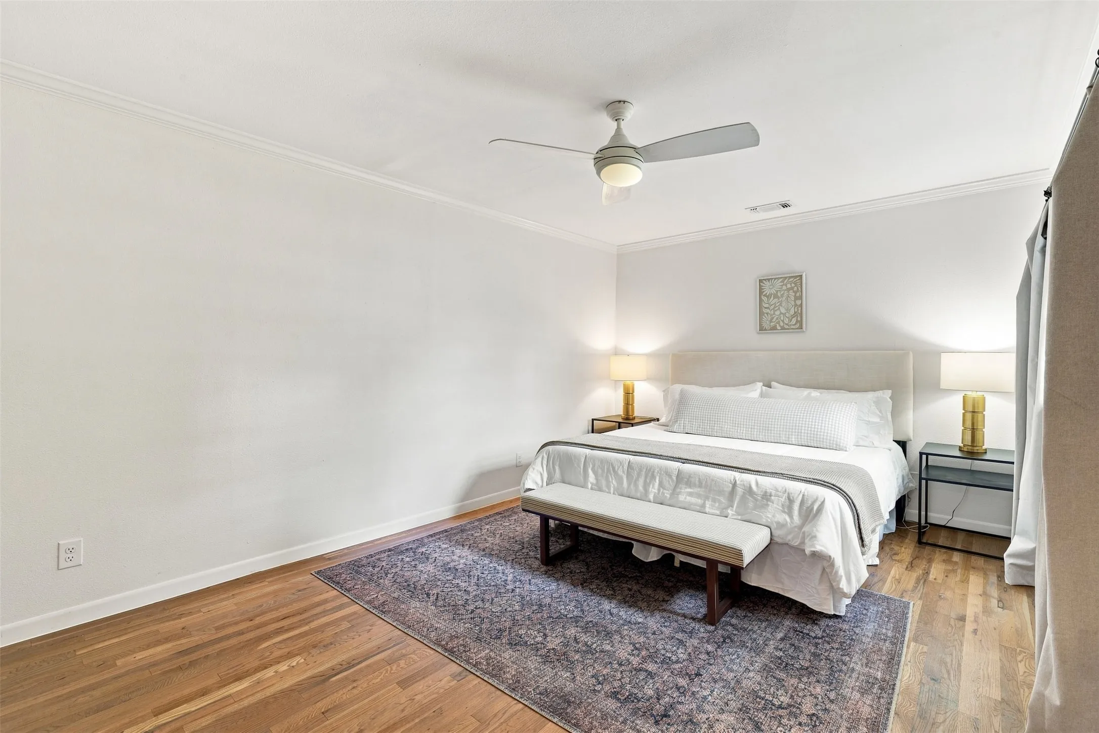 Tucked away privately from the main living area, the primary bedroom offers serene and peaceful retreat.