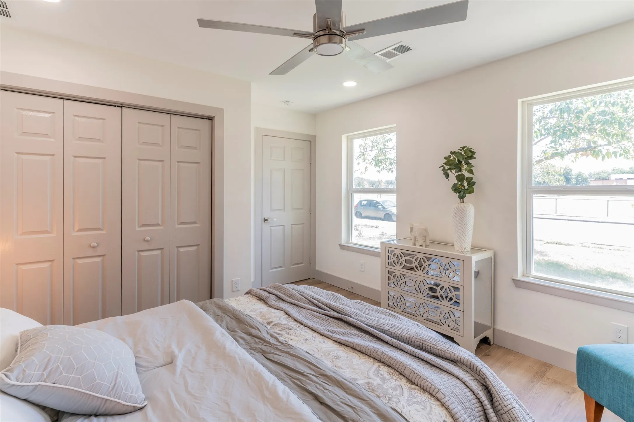 Recessed lighting, wood-finish flooring, and a ceiling fan with light fixture