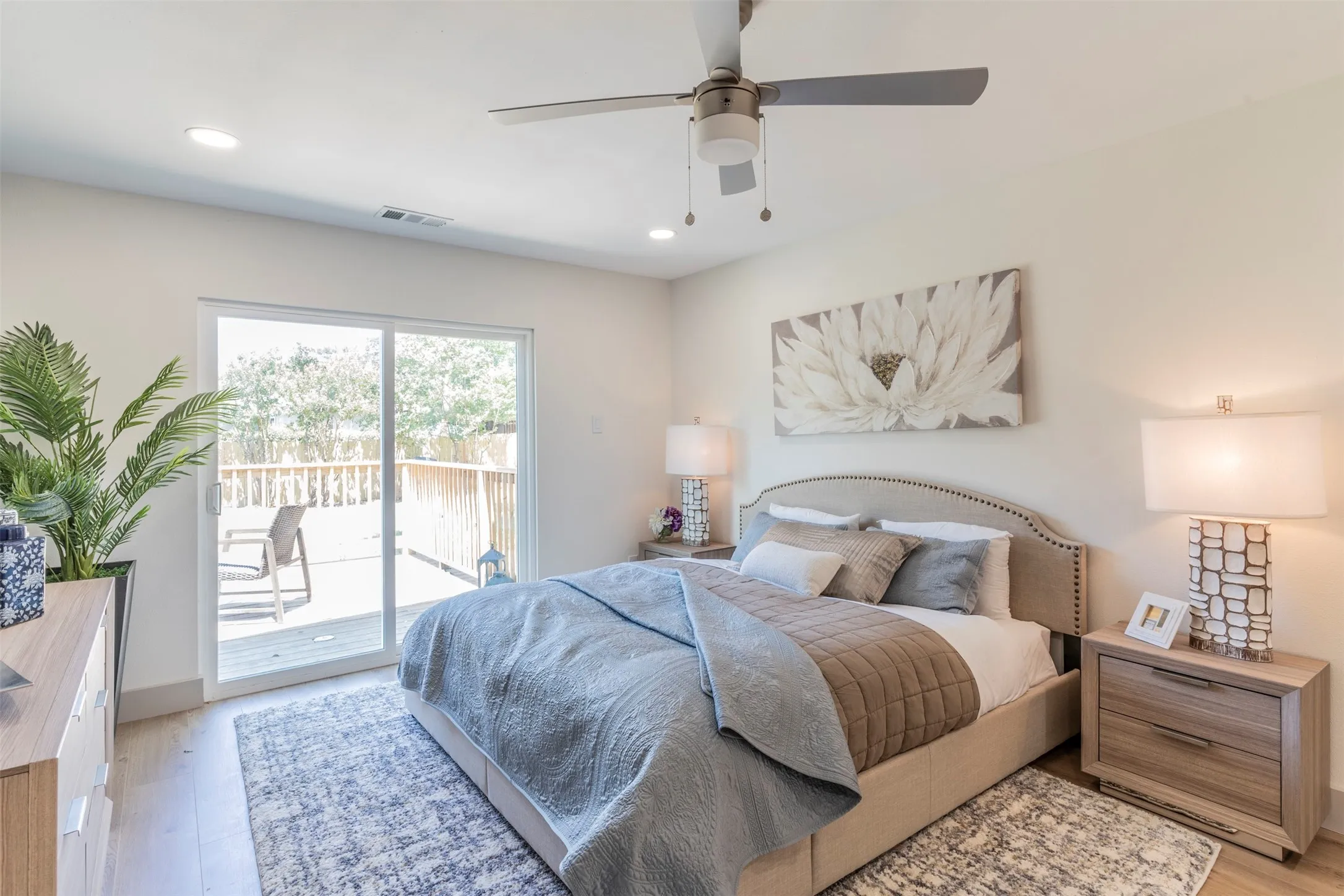 Recessed lighting, ceiling fan, wood-finish flooring, sliding glass door, and outdoor wooden decking