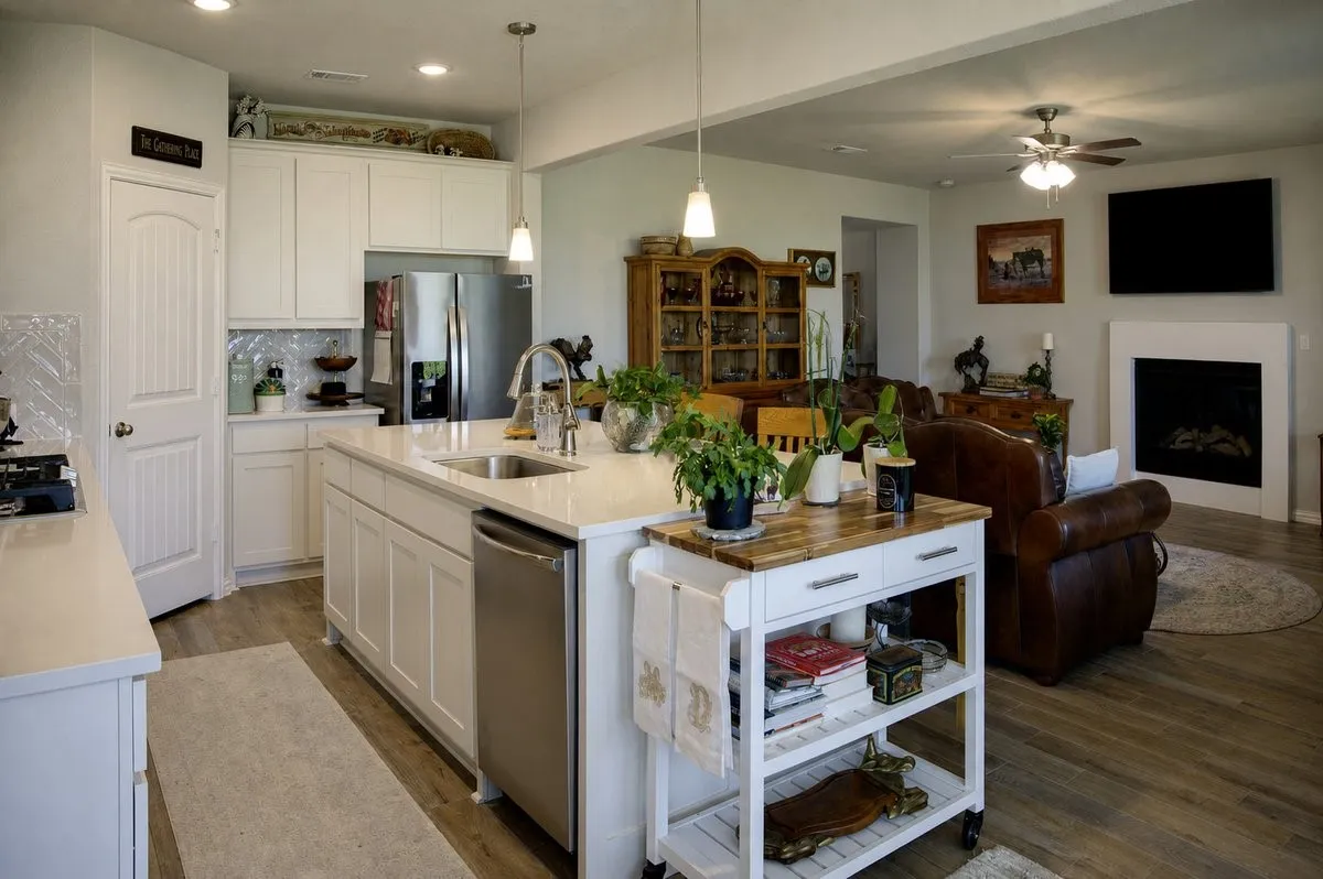 Open-concept kitchen and living area featuring wood-finish flooring