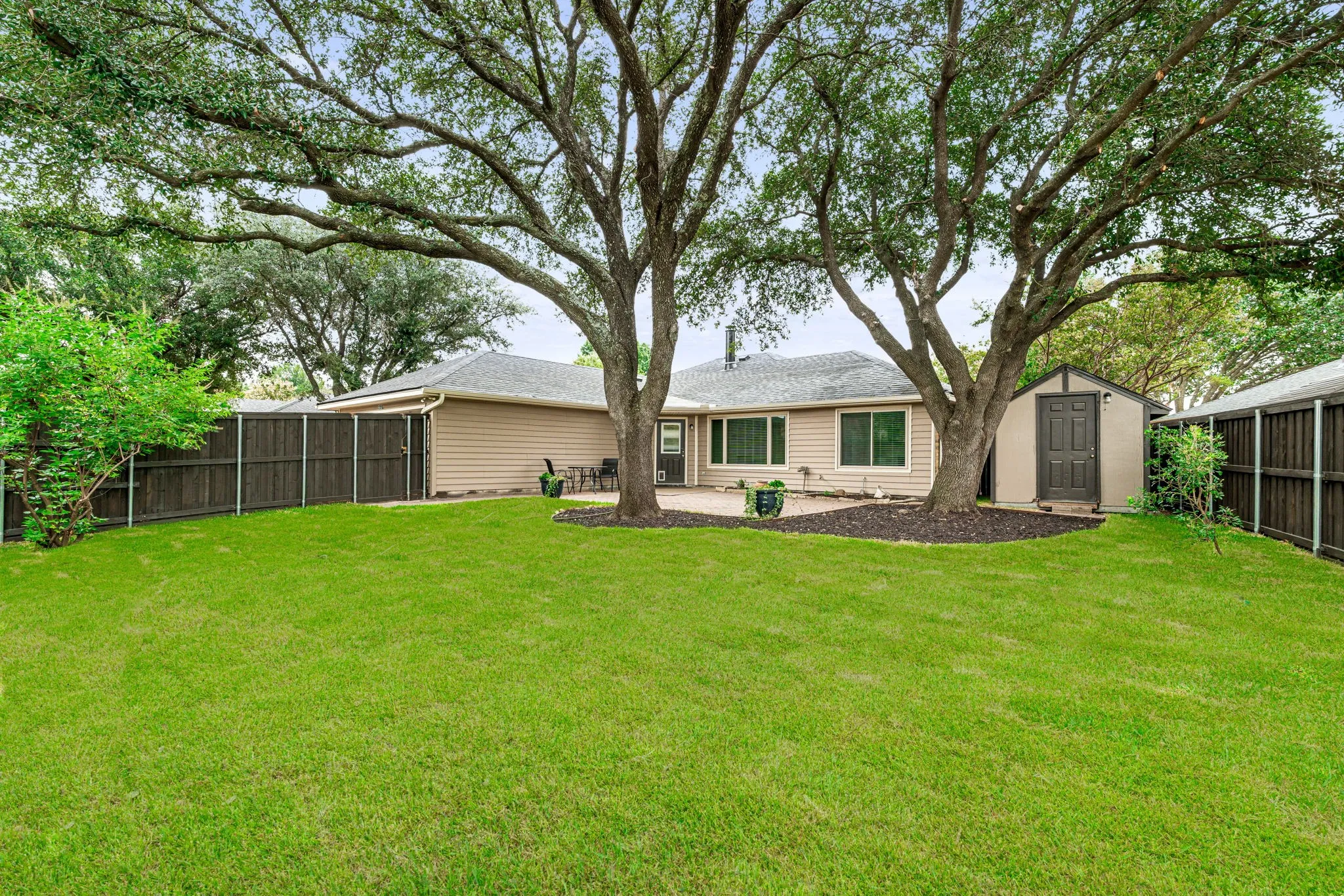 Backyard views - note the storage shed great for organizing yard equipment and outdoor items.