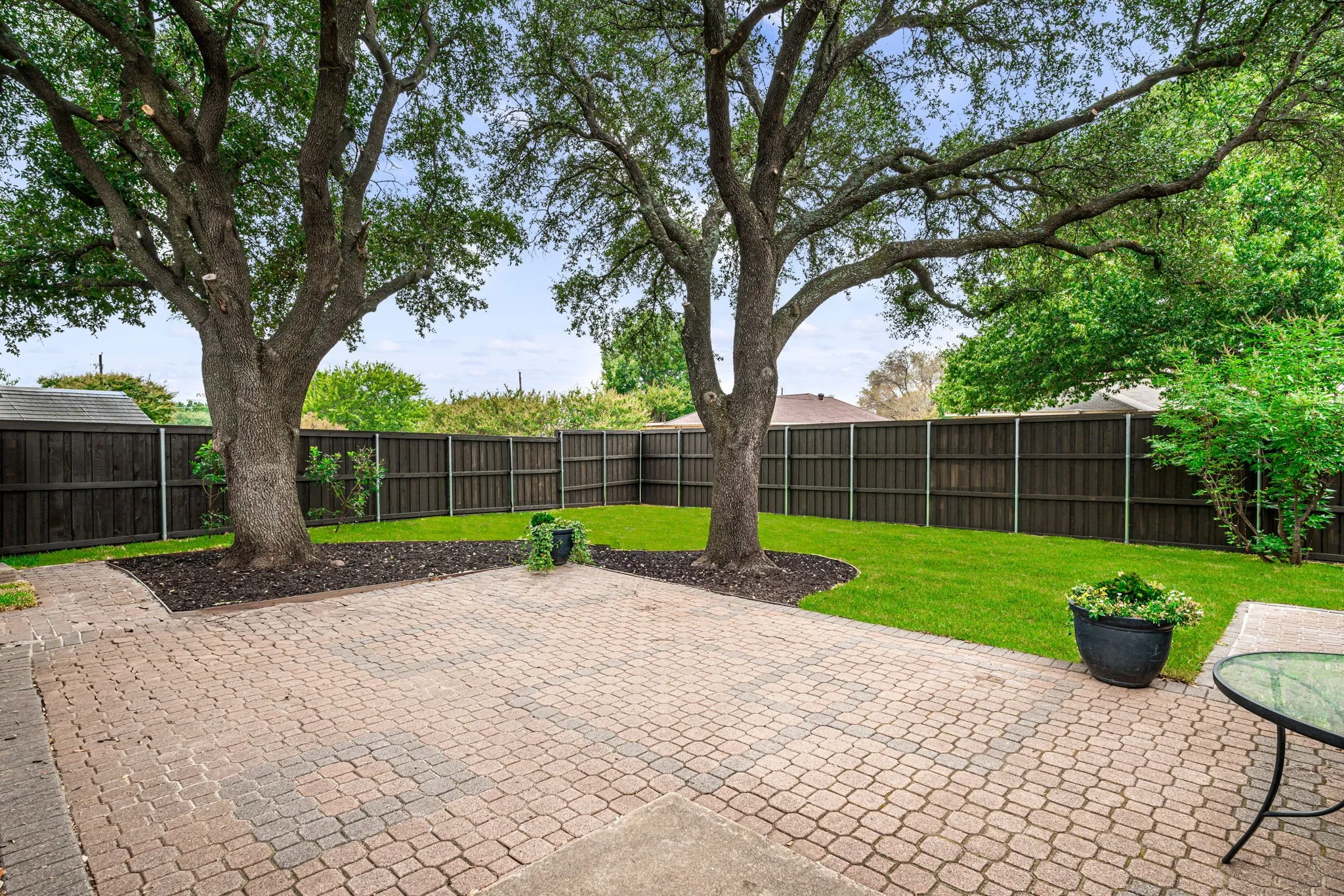 Large backyard with new board on board wood fence with metal poles. Nice lush grass.