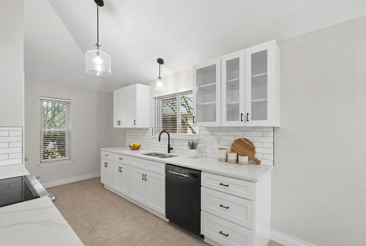 Updated Kitchen with quartz countertops, subway tile backsplash, new cabinets, stainless steel appliances and Bosch dishwasher.