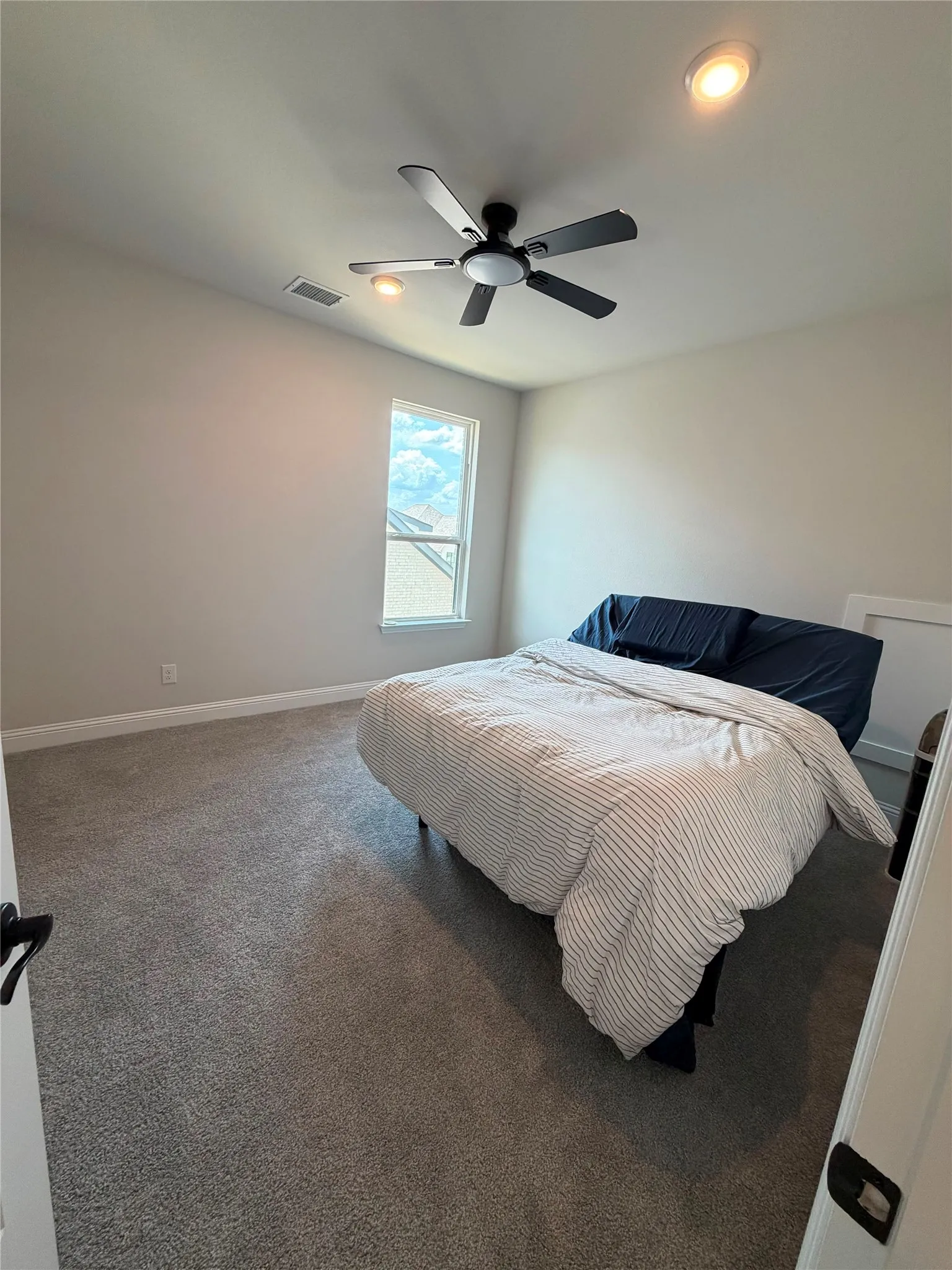 Wall-to-wall carpeting, recessed ceiling lighting, and a ceiling fan with integrated lighting