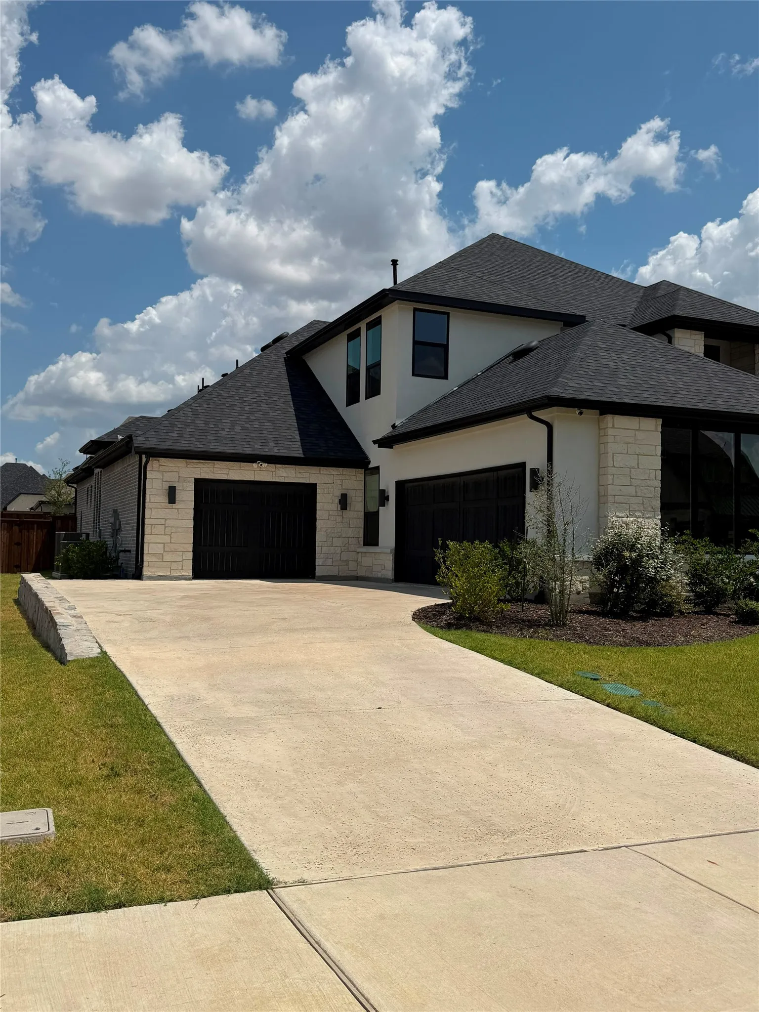 Contemporary exterior with light-toned stone and stucco finishes
