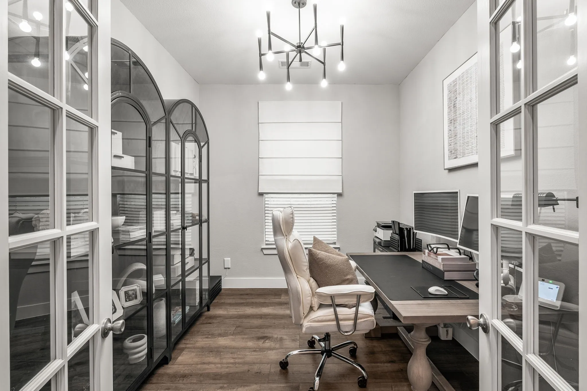 Dedicated office with French Doors and upgraded, designer lighting.