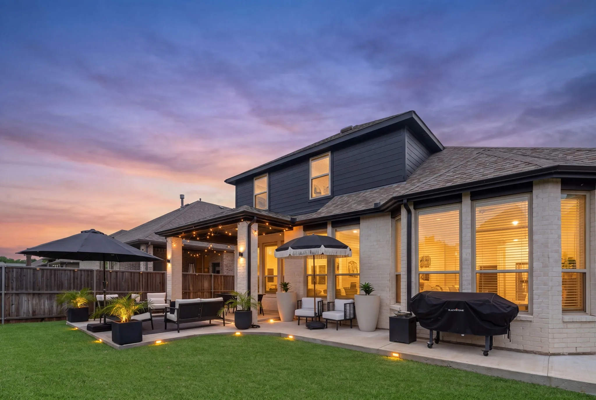 Large backyard with custom oversized extended patio and designed stone pathway.