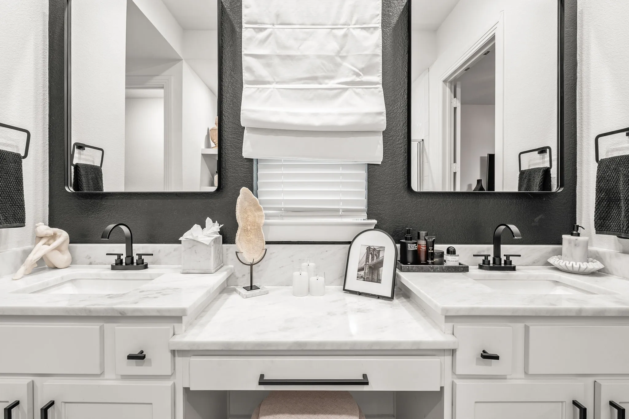 Primary bathroom with vanity sitting area.