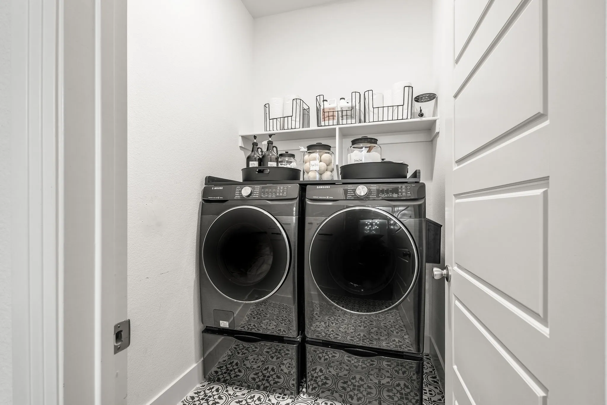 Separate utility room with full size washer/dryer area and designer tile.