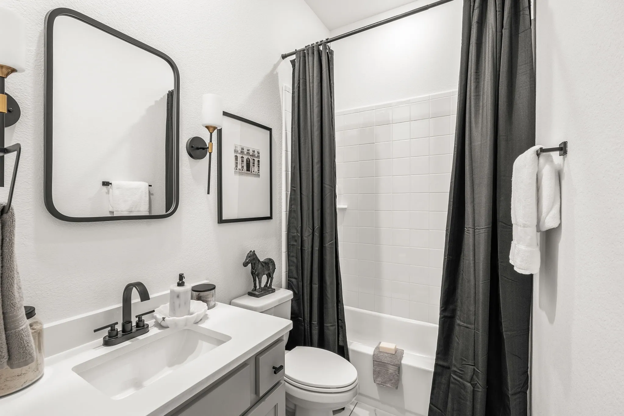 Adorable full bath downstairs servicing guests and downstairs secondary bedroom.