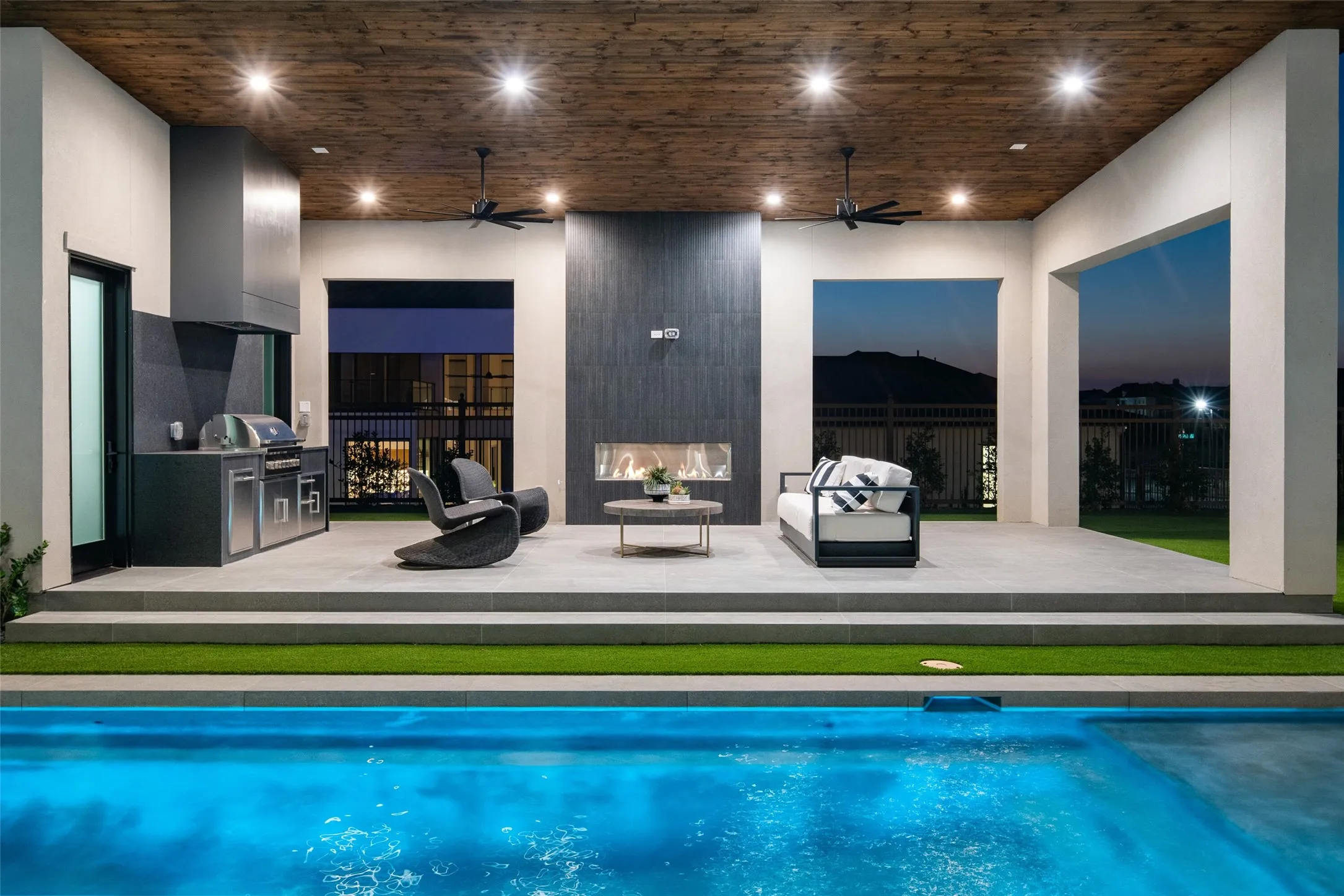 Covered patio with a wood-finish ceiling, recessed lighting, and ceiling fans