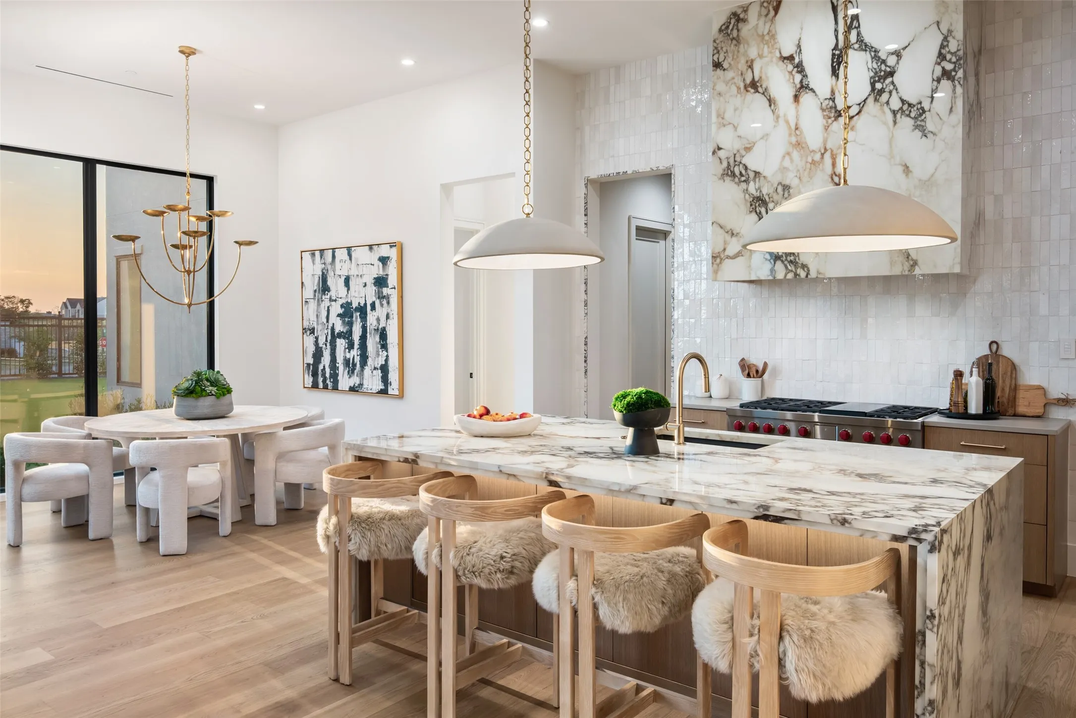Waterfall island with  wood-finish flooring, and built-in range