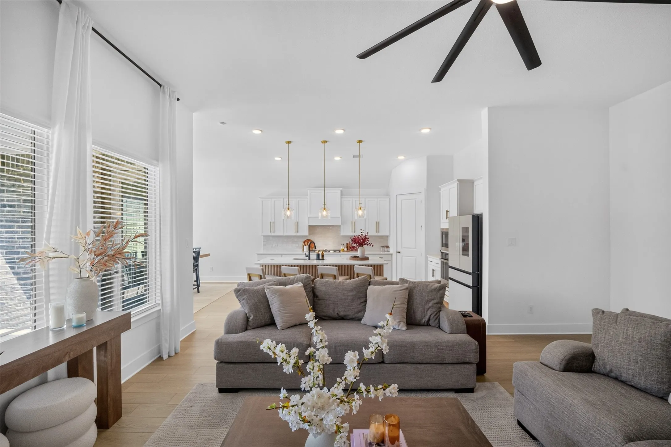High ceilings, recessed lighting, and wood-finish flooring