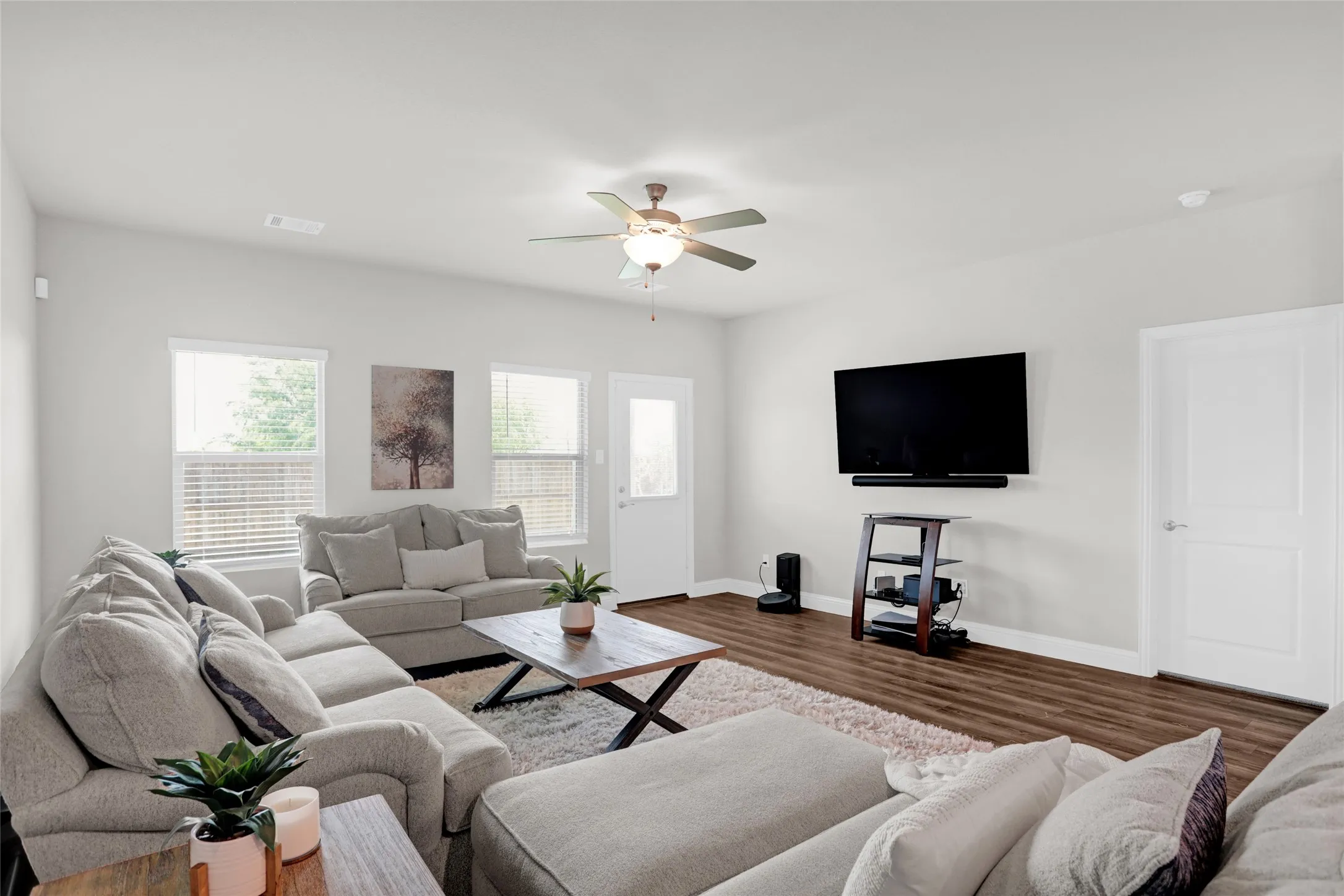 Living room featuring wood finished floors and a ceiling​​‌​​​​‌​​‌‌​‌‌​​​‌‌​‌​‌​‌​​​‌​​ fan