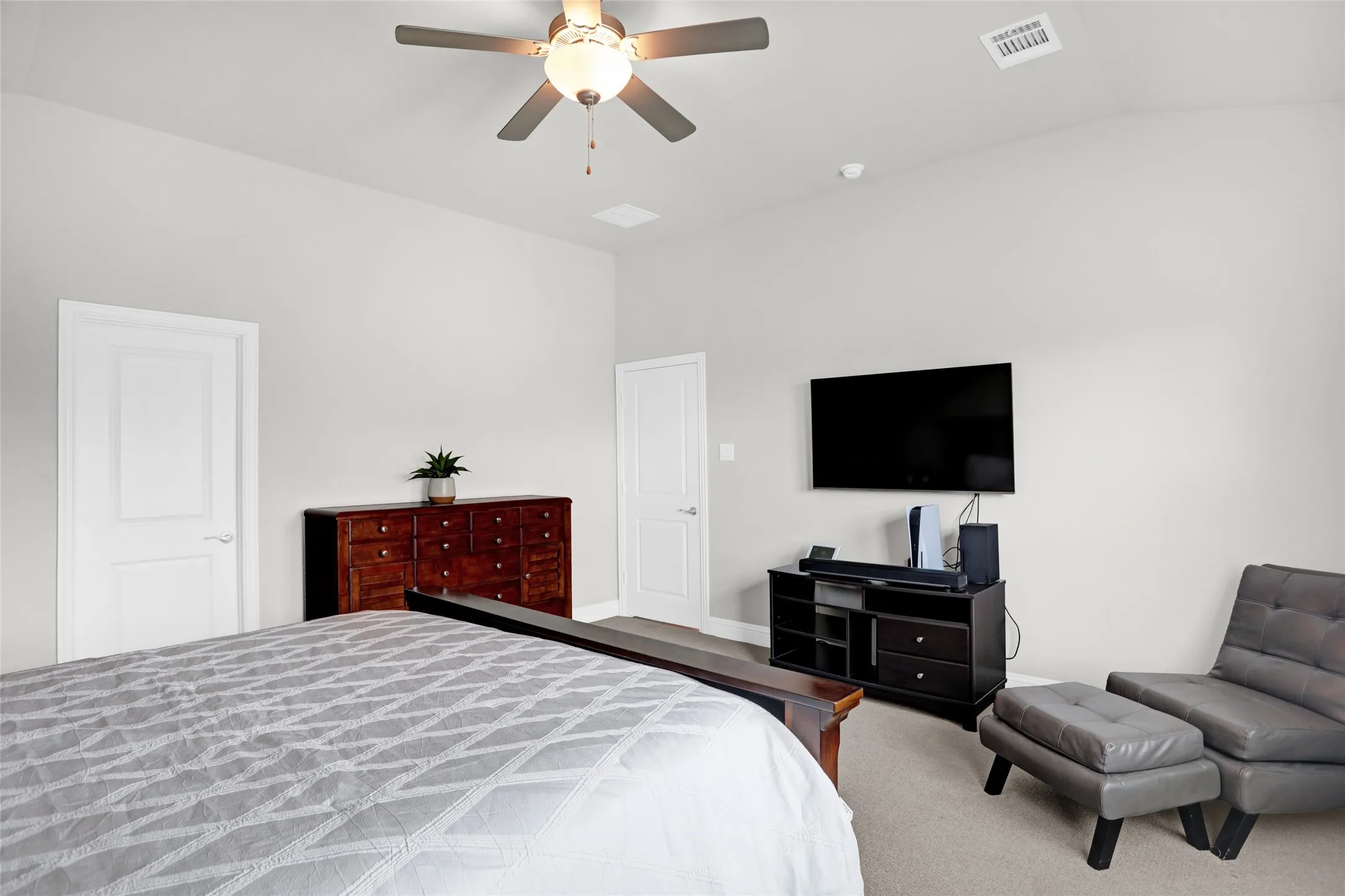 Bedroom with a ceiling fan and lofted ceiling