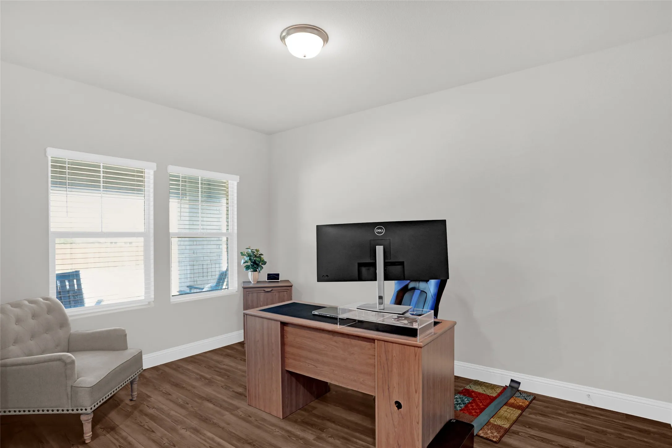 Home office with baseboards and wood finished floors